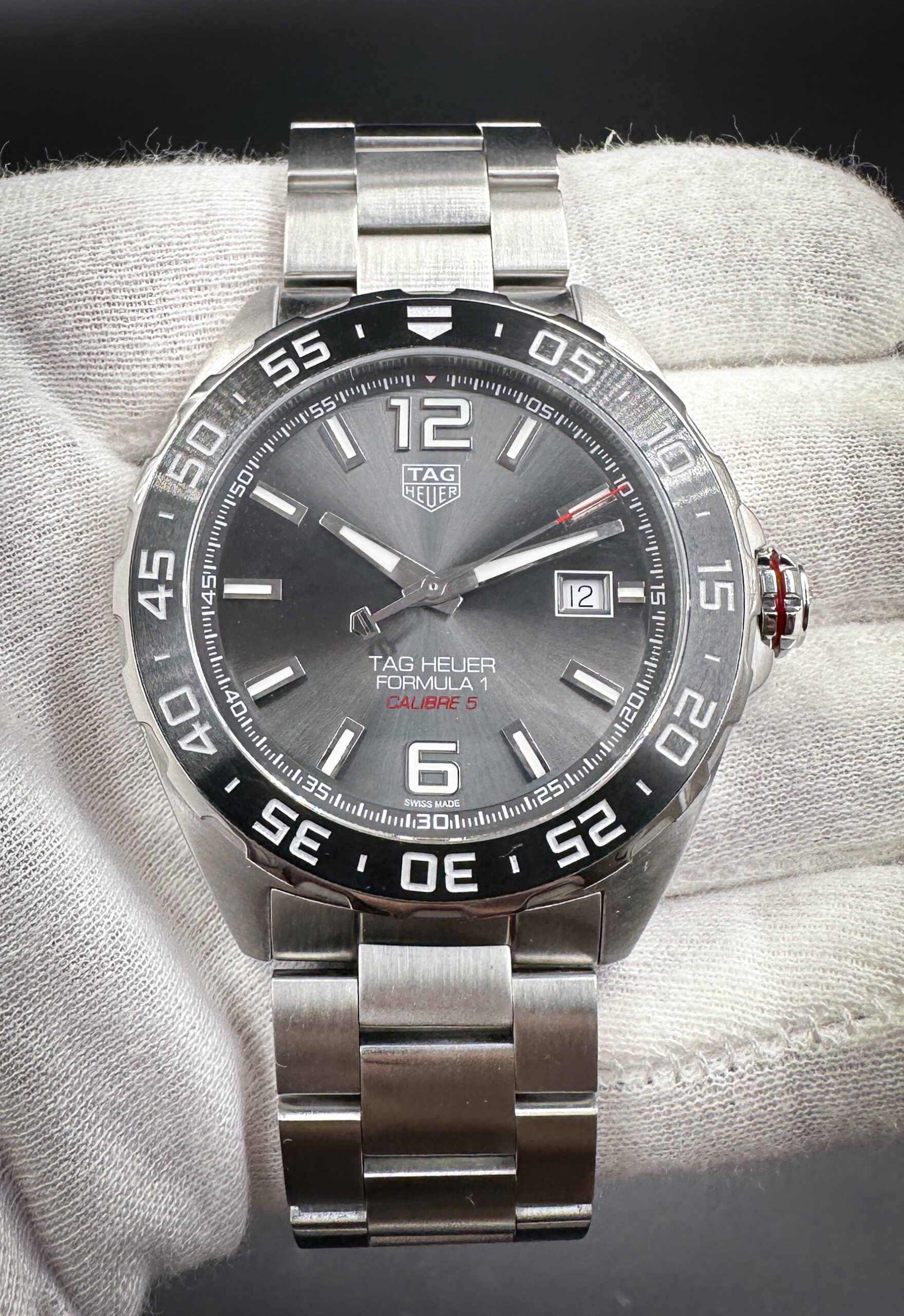 TAG Heuer Formula 1 Ref. WAZ2011 in a 43mm stainless steel case, featuring the automatic TAG Heuer Caliber 5 movement. This watch includes the outer box, inner case, instruction booklet and open warranty card. The bracelet has nine (9) removable links currently installed and will fit a 8.5 inch wrist.