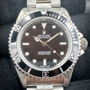 1996 Rolex Submariner 14060 (T-Serial) in a 40mm stainless steel case, featuring the Rolex calibre 3000 automatic movement. This Submariner features and unique tropical dial and includes: the outer box, inner case, folder, Submariner booklet; Oyster booklet; Factory Service Booklet; seal hangtag; original bezel insert; and TLC warranty card.