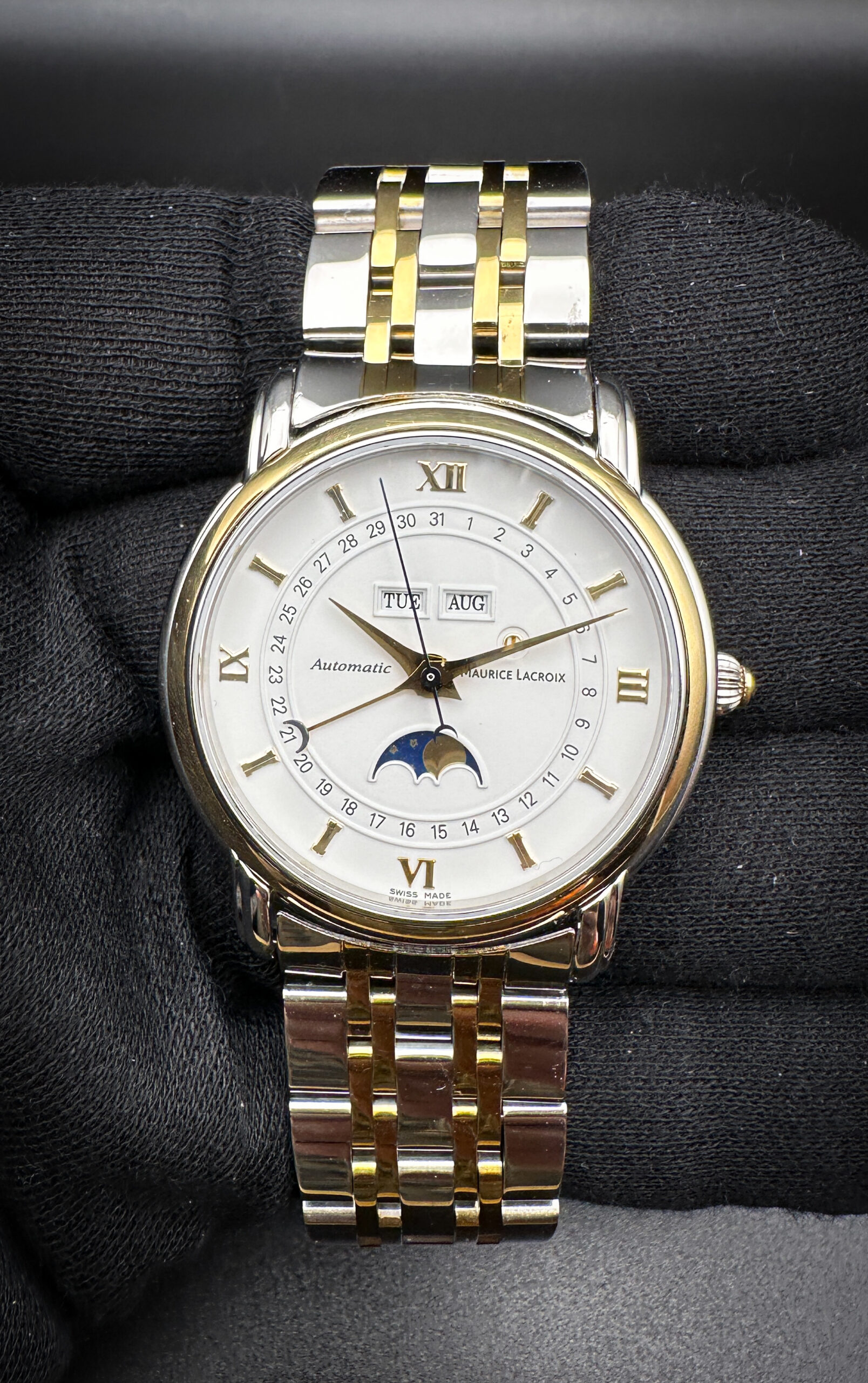 Maurice Lacroix Masterpiece Phase De Lune Ref. 37757 in a 38mm stainless steel and yellow gold case, featuring the ETA 2824-2 automatic movement. This Maurice Lacroix has been tested in excellent working order and includes the original box, booklet, open warranty card, and the original leather strap with buckle.