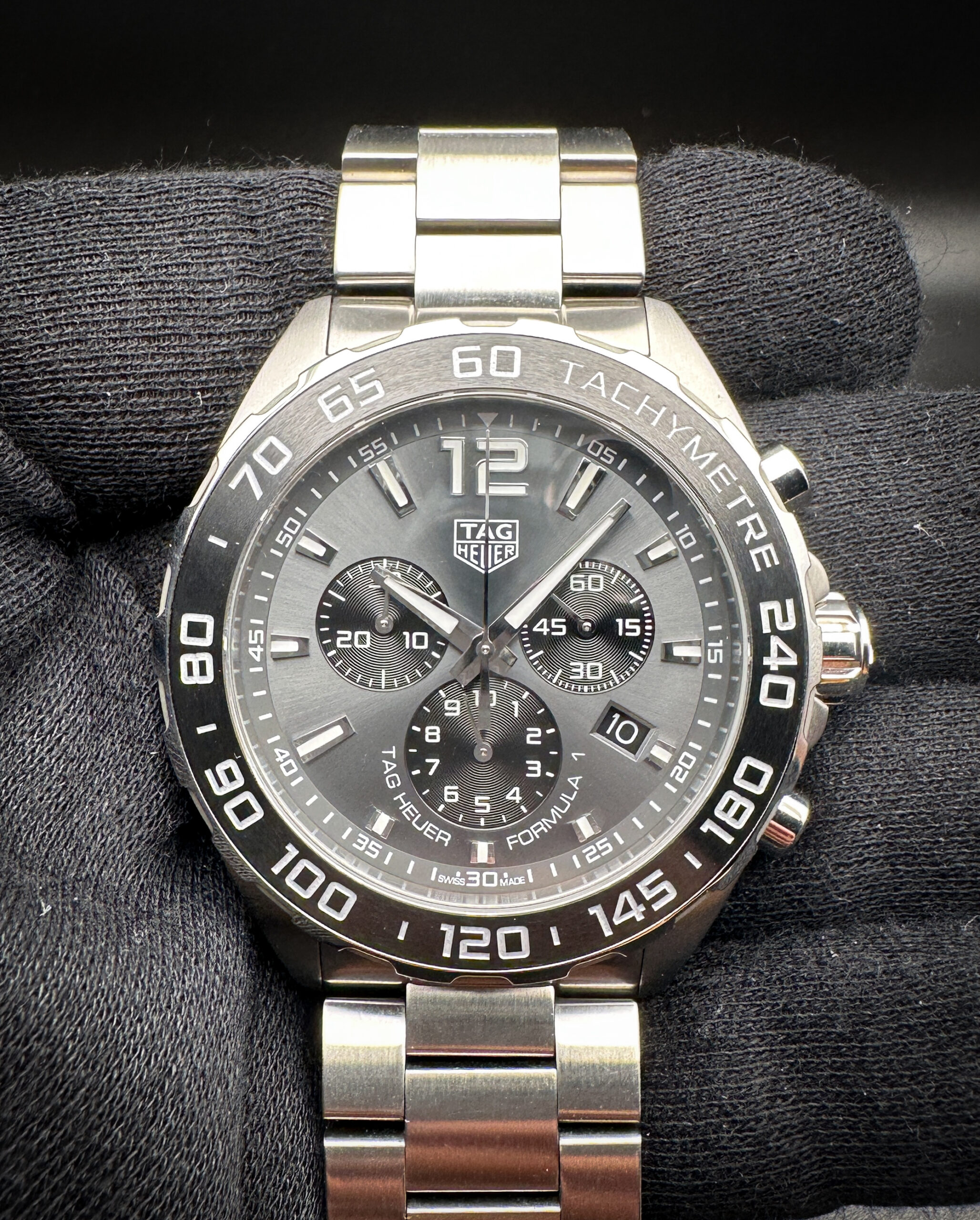 Tag Heuer Formula 1 Chronograph CAZ.1011 in a 43mm stainless steel case, powered by a Tag Heuer quartz movement. This watch includes: Outer Case, Folder, TH Thank you card; travel case; display box, instruction booklet; open warranty card; hang-tag; and extra links.
