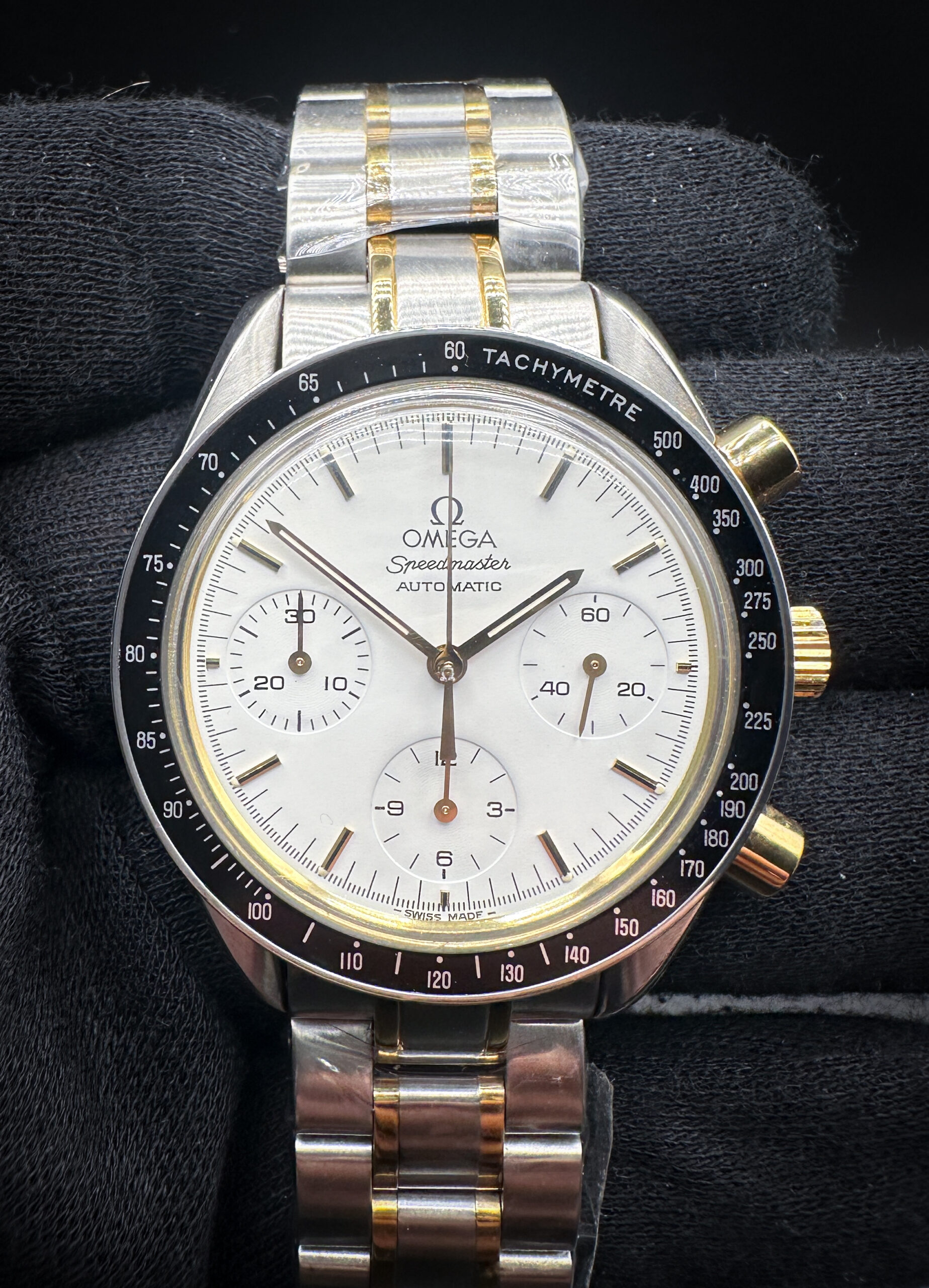 Omega Speedmaster "Reduced" 3310.20.00 in a 39mm yellow gold and stainless steel case, featuring the Omega 1143 automatic movement. This Omega has been tested in good working order and is ready for wear or to be added to a collection. The caseback features three distinct service marks.