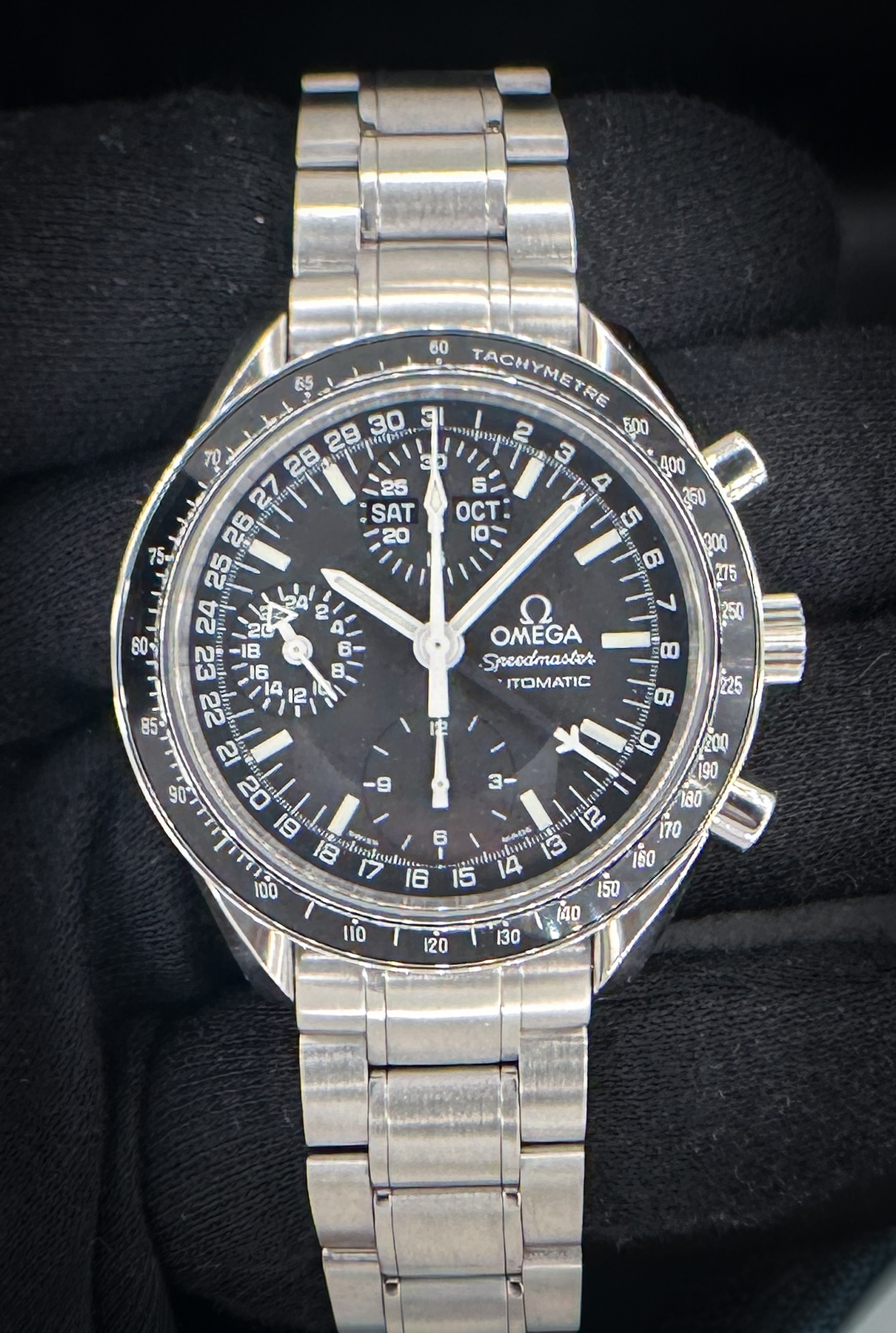 Omega Speedmaster Day-Date Triple Calendar 3520.50 in a 39mm stainless steel case, featuring the Omega caliber 1151 automatic movement. This Speedmaster has been tested in excellent working order and is ready for wear or to be added to a collection. Includes the Omega outer box, inner wooden case, travel case, instruction book, wallet, and TLC warranty card. Caseback Serial Number: 57946XXX