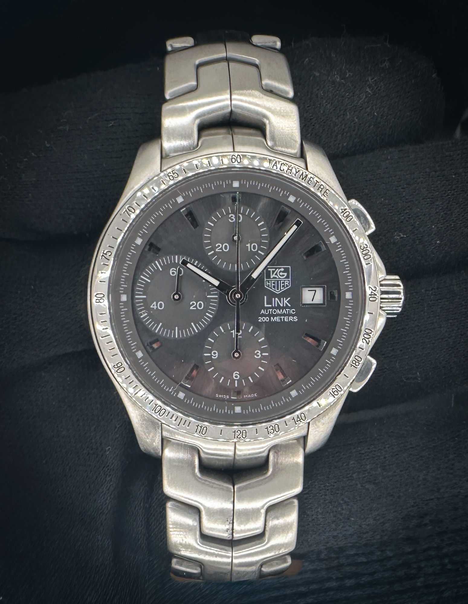 Tag Heuer Link Chronograph in a 42mm stainless steel case, powered by the Tag Heuer caliber 16 automatic movement. This Link has been tested in excellent working order and is ready for daily wear or to be added to a collection. Includes a new Wrist Wraith watch roll, and TLC Authentication/Warranty card. Case Serial Number: VY14XX