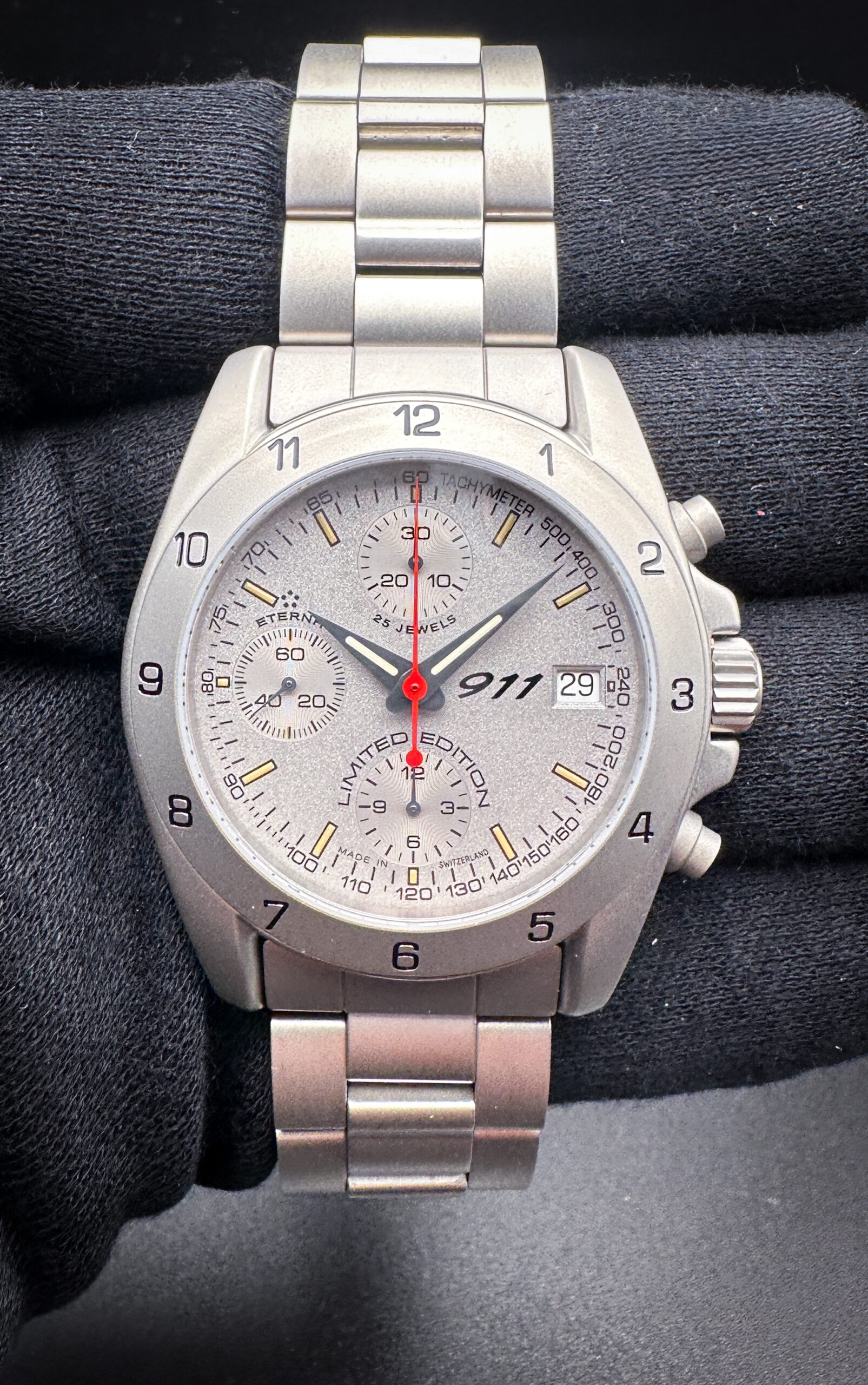 Unworn Eterna Porsche 911 Chronograph 1506.41 Limited Edition No. 1666/1911. This Eterna has been tested in excellent working order and still has the protective film on the caseback and buckle. Includes: 911 outer box, inner case, Porsche 911 booklet; and open warranty card signed by Dr. Wendelin Wiedeking - Porsche AG.