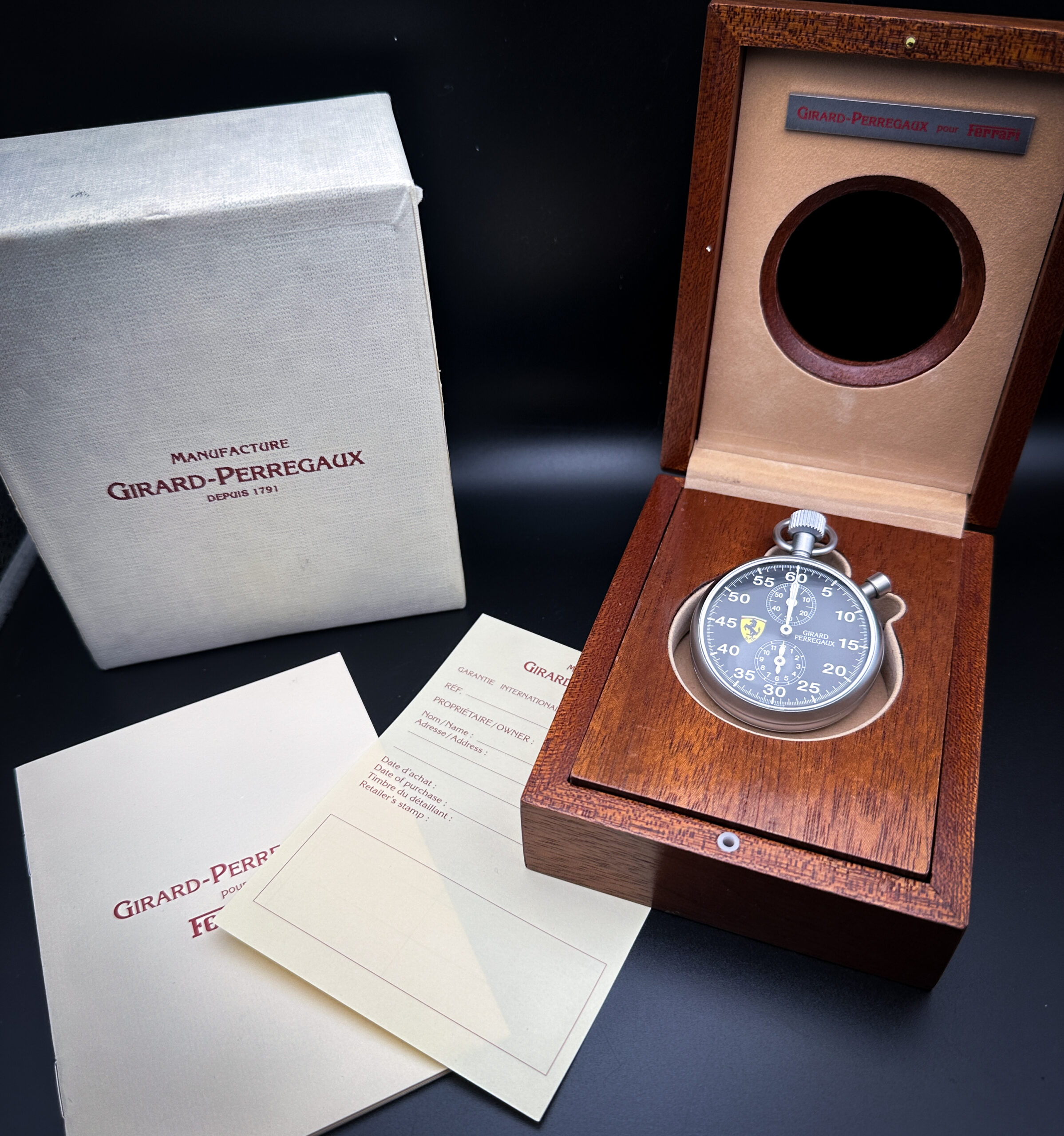 Girard-Perregaux pour Ferrari Sport Timer Limited Edition Stopwatch No. 600, Ref. 89600.0.12.6156. Limited production of less than 1000 pieces in 1990s. Encased in a lightweight titanium case, tempered to give a satin-like yet hard-wearing matte surface finish. The timer comes in its original wooden presentation box, with all documents and even a brown leather lanyard, which snaps on to the crown attachment.