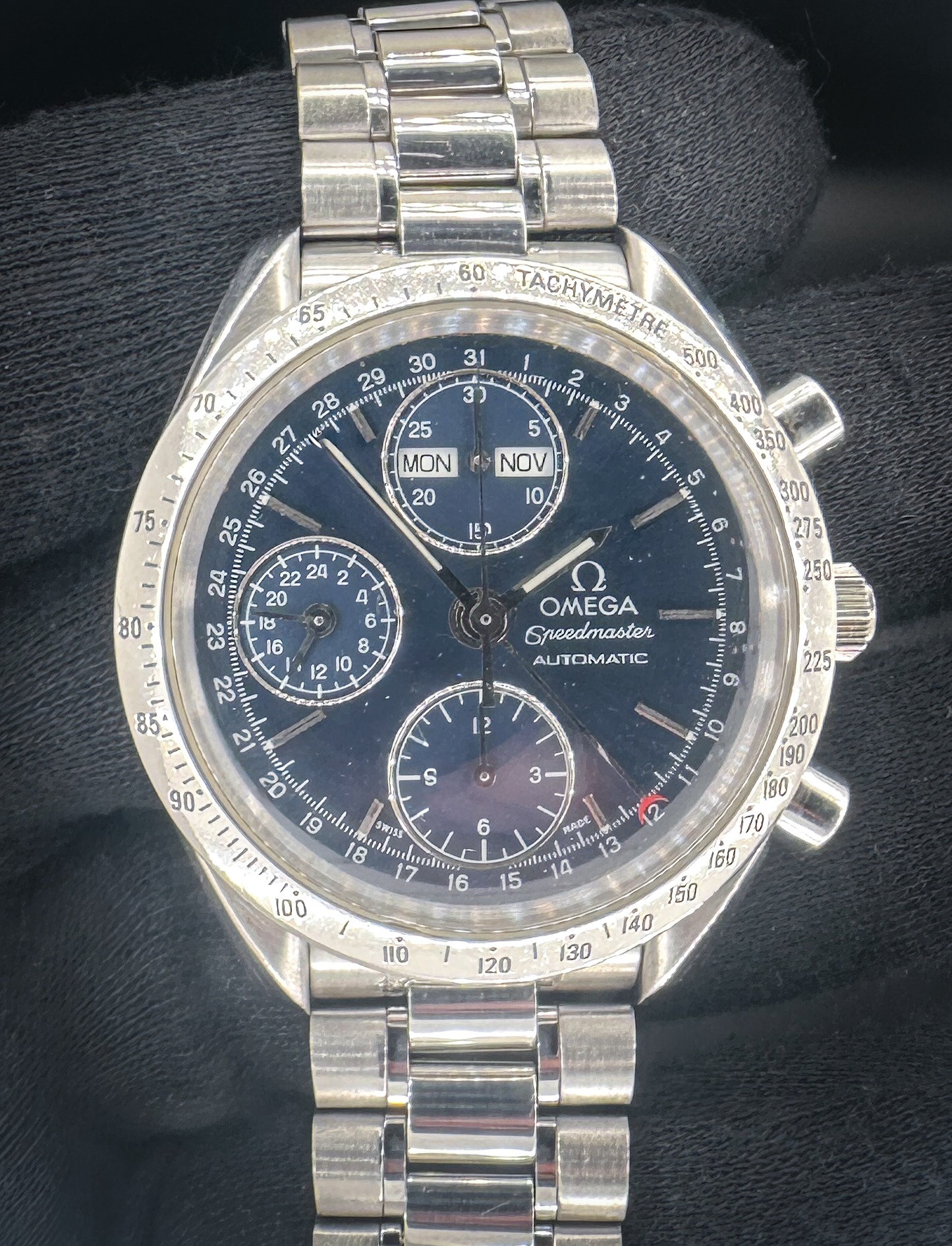 Vintage c. 1995 Omega Speedmaster Day-Date Triple Calendar 3521.80 in a 39mm stainless steel case, featuring the Omega caliber 1151 automatic movement. This Speedmaster has been tested in excellent working order and is ready for wear or to be added to a collection. Includes the Omega outer box, inner wooden case, travel case, instruction book, wallet, and TLC warranty card. Caseback Serial Number: 55806XXX