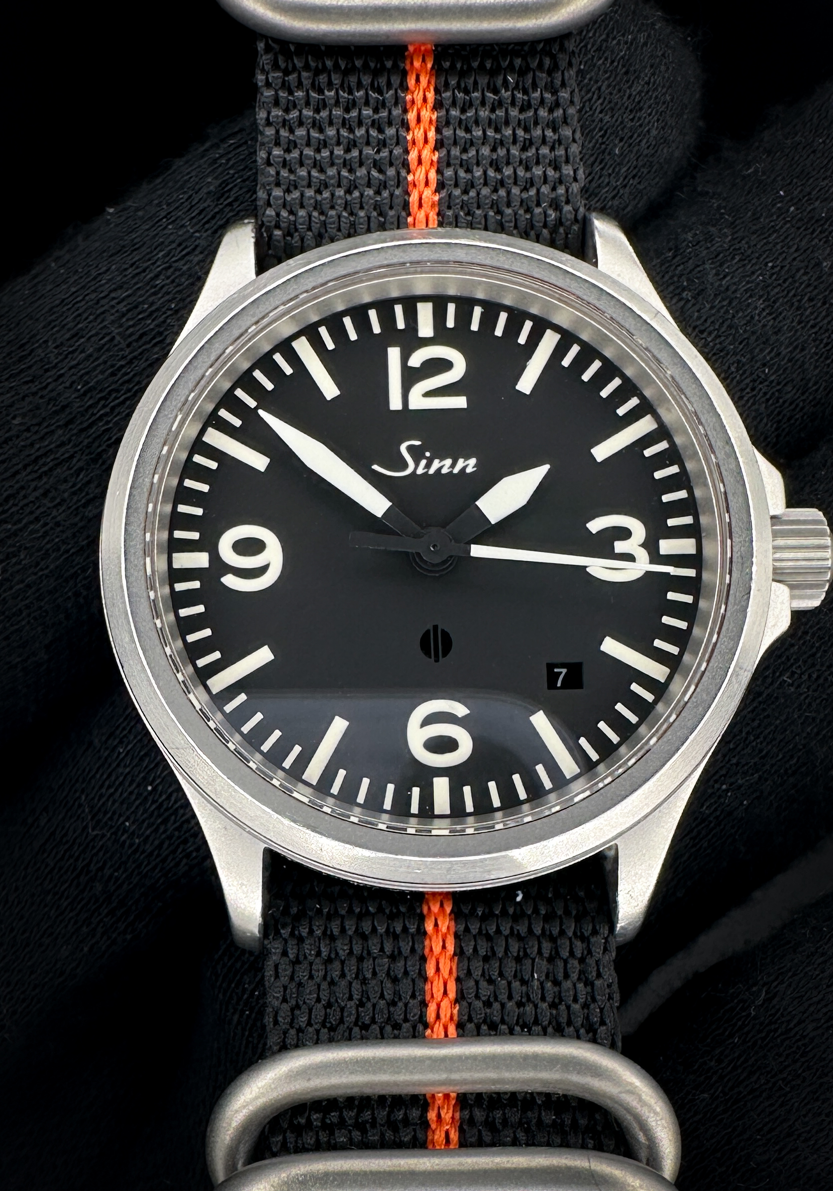 Sinn 656.1019 Fliegeruhr Pilot Cockpit in a 39mm stainless steel case, featuring the ETA 2824-2 automatic movement. This Sinn has been tested in excellent working order and is ready for wear or to add to a collection. Includes a new black/orange NATO Strap; new black leather strap; and new Wrist Wraith watch roll.
