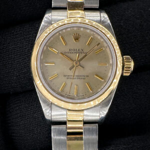 1990 Rolex Oyster Perpetual 67183 in a 26mm yellow gold and stainless steel case, powered by the Rolex 2130 automatic movement. This Rolex has been tested in excellent working order and is ready for wear. Includes a new black travel case, and TLC warranty/authentication card. Case Serial Number: E667XXX