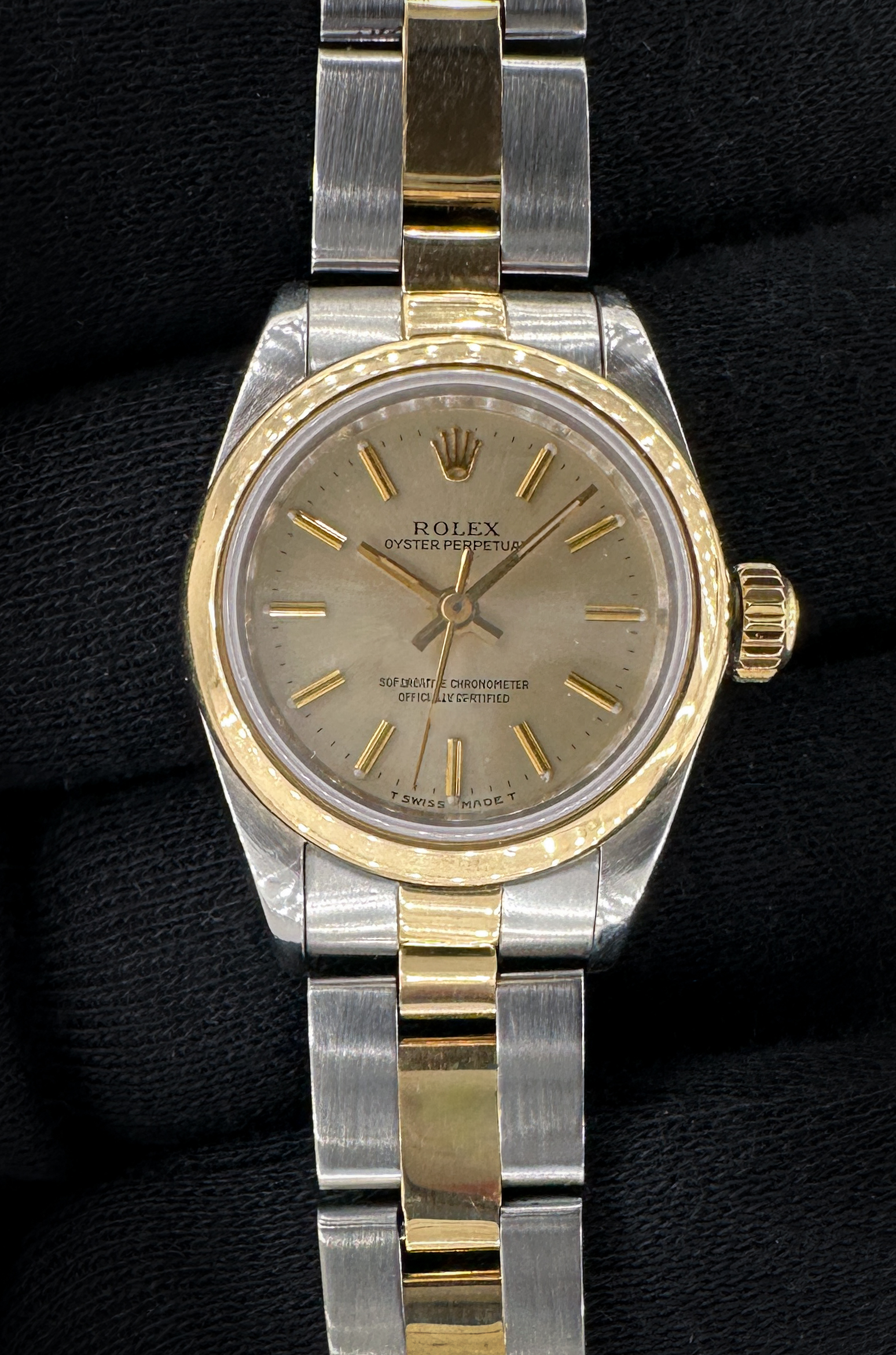 1990 Rolex Oyster Perpetual 67183 in a 26mm yellow gold and stainless steel case, powered by the Rolex 2130 automatic movement. This Rolex has been tested in excellent working order and is ready for wear. Includes a new black travel case, and TLC warranty/authentication card. Case Serial Number: E667XXX