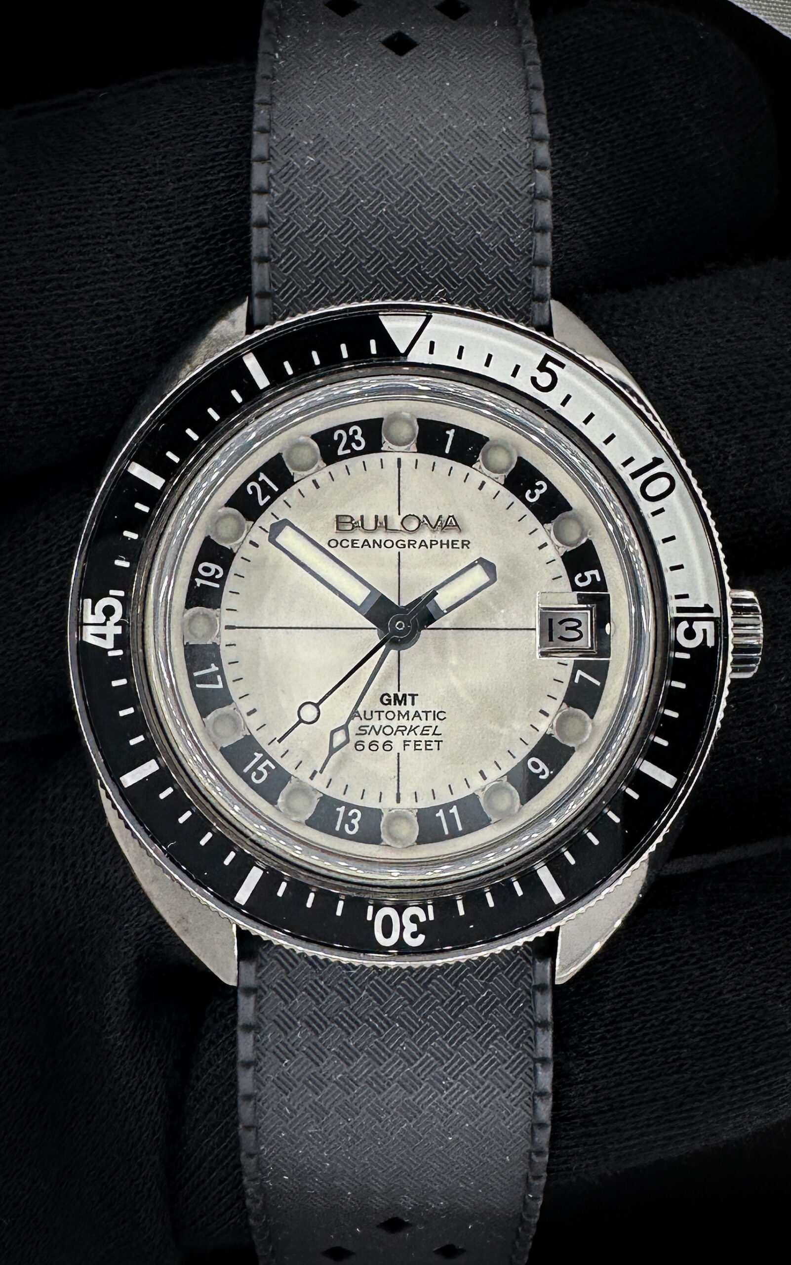 Bulova Oceanographer Snorkel "Hell Diver" GMT 98B407 in a 41mm grey IP-coated steel case, with full Lume dial, powered by the Bulova 9075 automatic movement. This Bulova includes a new Wrist Wraith travel roll, and TLC Warranty/Authentication card. This Bulova is pre-owned and in excellent condition, with no marks.  Includes the original grey Bulova two-piece strap, as well as a new black diver strap. 