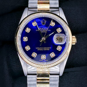 Vintage 1991 Rolex Oyster Perpetual Date 15203 in a 34mm yellow gold and stainless steel case, featuring a custom diamond-marker blue-pearl dial, powered by the Rolex caliber 1570 automatic movement. This Rolex has been tested in excellent working order and includes a new Wrist Wraith travel case, and the TLC warranty and authentication card.  Case Serial Number: X964XXX