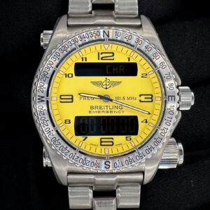 Like-New Breitling Emergency E56321 in a 43mm titanium case, powered by the Breitling 56 quartz movement. This Breitling has been tested in excellent working order with all batteries in the watch, transmitter, and tester replaced November 2025. Includes: Breitling carrying case; chronometre certificate; punched warranty booklet; hang tag; transmitter tester; screwdriver; emergency tag; instructions booklet; and sealed VHS tape.