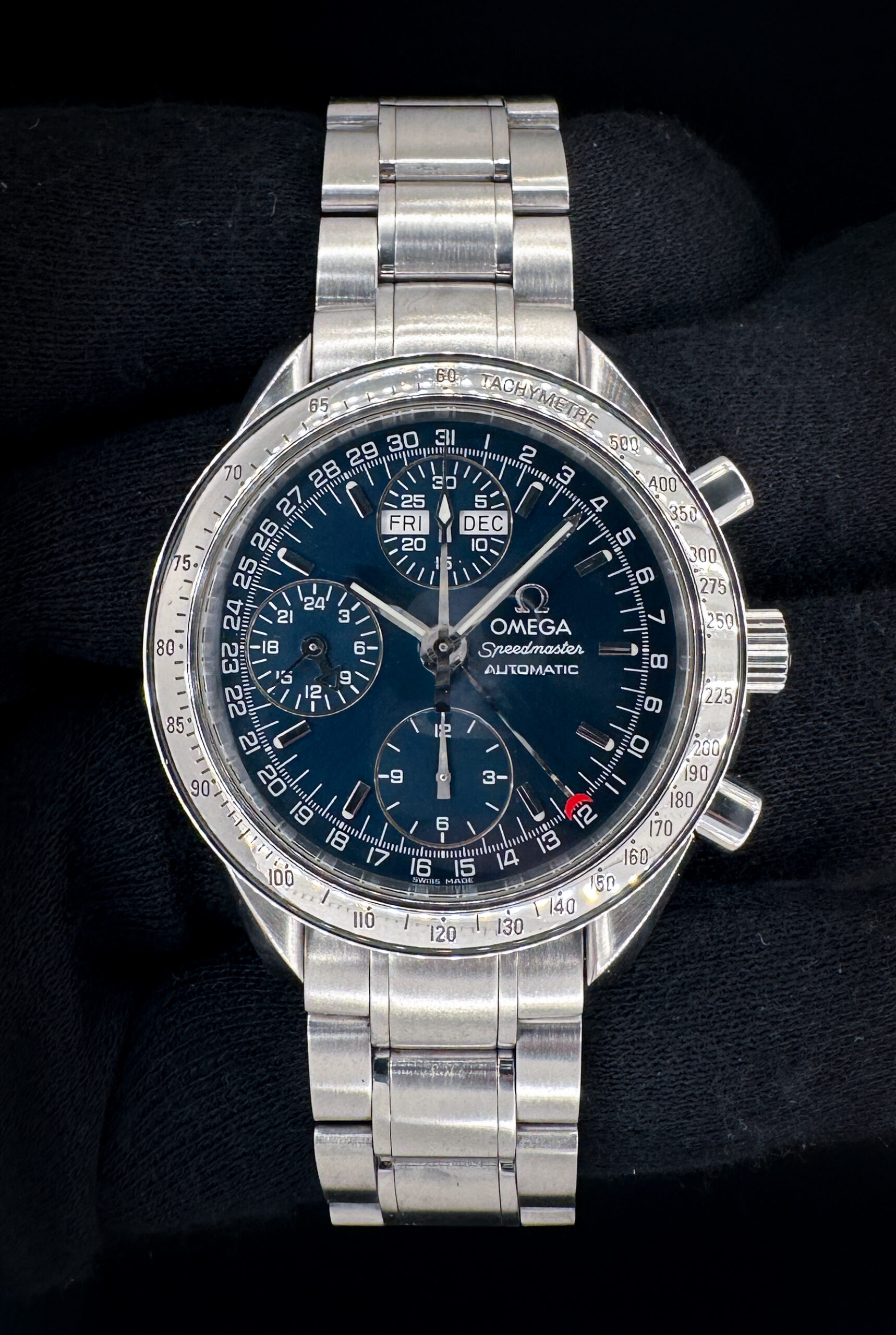 Vintage c. 1999 Omega Speedmaster Day-Date Triple Calendar 3523.80 in a 39mm stainless steel case, featuring the Omega caliber 1151 automatic movement. This Speedmaster has been tested in excellent working order and is ready for wear or to be added to a collection. Includes the Omega outer box, inner wooden case, travel case, instruction book, wallet, and TLC warranty card. Caseback Serial Number: 558569XXX