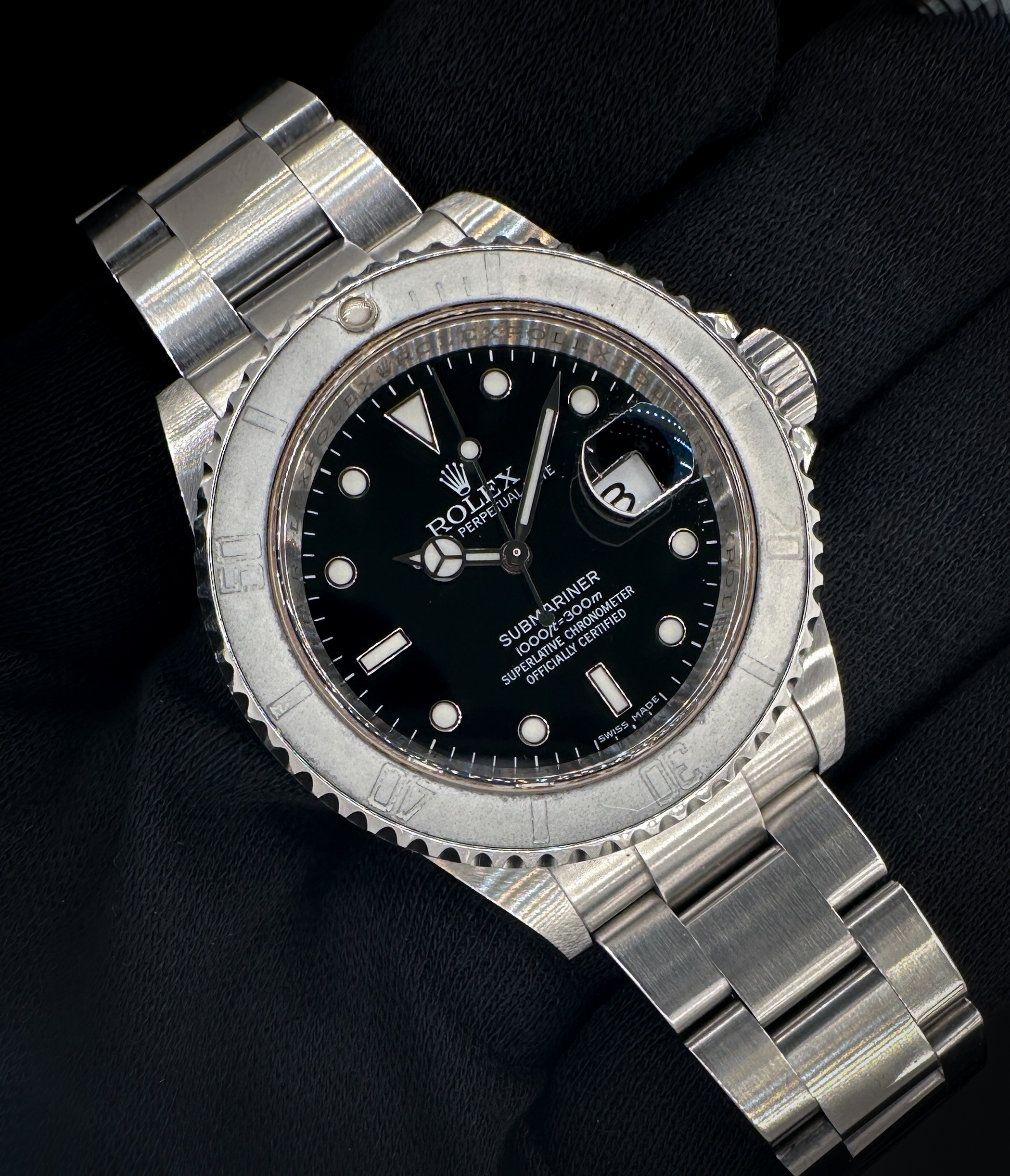 2009/2010 Rolex Submariner Date 16610 in a 40mm stainless steel case, powered by the Rolex caliber 3135 automatic movement, featuring a super-ghost patina bezel. This Submariner includes: Outer sleeve; outer box; inner case; bezel protector; polishing cloth; Swimpruf tag (matching serial); red Rolex tag; Submariner booklet; Service Booklet; instruction booklet; leatherette wallet; and warranty card (dated 11MAR2010). Serial Number: V910XXX