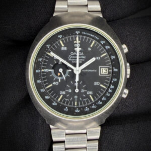 Offered here is the bold and unmistakably 1970s Omega Speedmaster Mark III 176.002, featuring a black dial and fitted to its original 1162/172 stainless steel bracelet. This reference showcases the dramatic “volcano” style case, characterized by its angular architecture and raised inner bezel profile. The sculpted stainless steel case gives the watch substantial wrist presence while remaining balanced and wearable — a true product of Omega’s forward-thinking design era. The crystal is clear and free of scratches or edge-chips. The original dial and hands show a light patina consistent with age, with a beautiful patina to the lume paint. The case shows wear consistent with its 50-year age. The black dial offers strong contrast and excellent legibility, with the distinctive central chronograph seconds and central chronograph minute display — a signature feature of the celebrated Omega Caliber 1040. This early automatic chronograph caliber represents a pivotal technical milestone for Omega, incorporating a 24-hour indicator and date function while delivering reliable, robust performance. This original 1040 retains the serial-numbered automatic rotor.