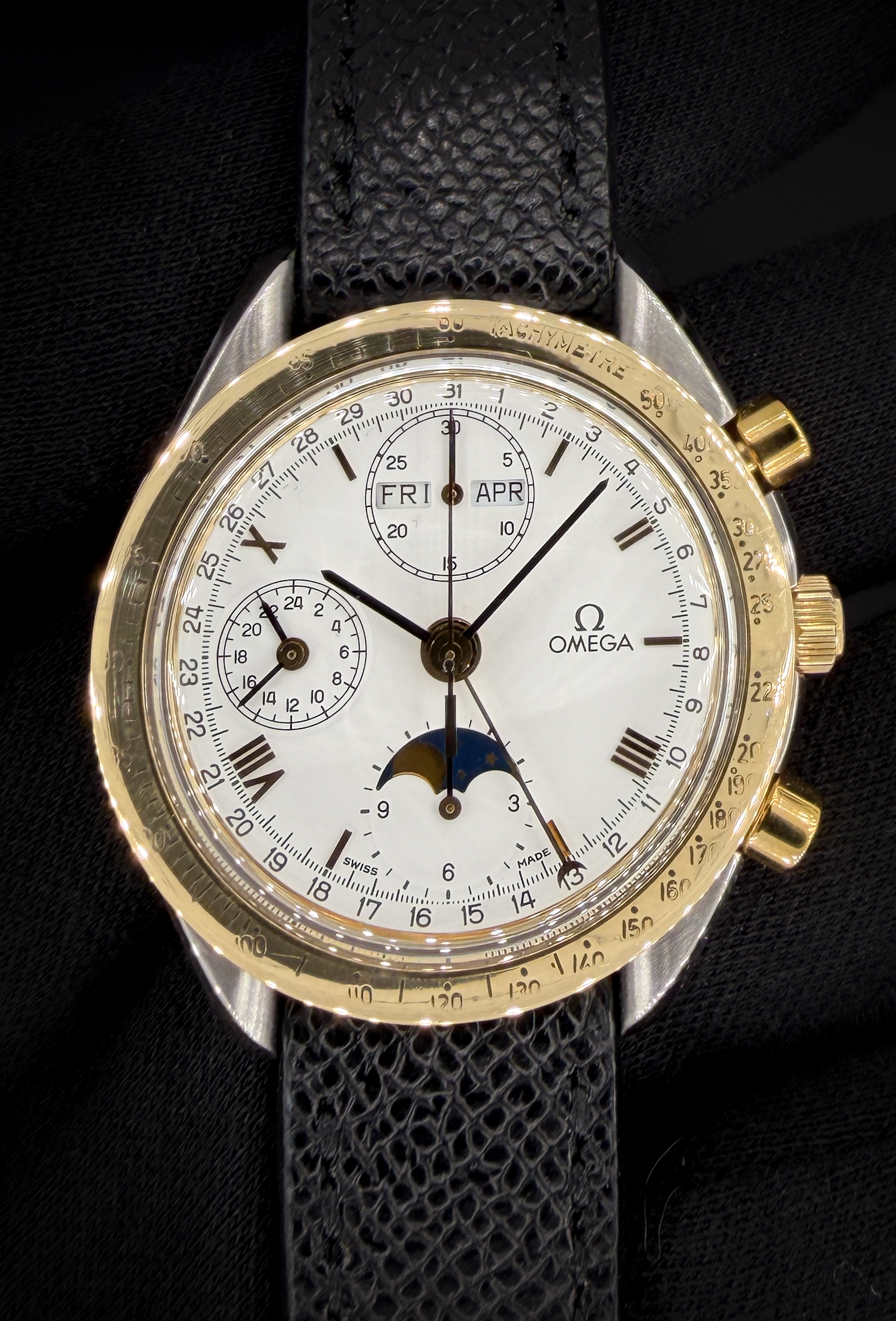 Vintage c. 1990 Omega Speedmaster Classic Day-Date Moonphase 175.0035 in a 39mm stainless steel and yellow gold case, powered by the Omega 1150 automatic movement. This Speedmaster has been tested in excellent working order and is ready for wear or to be added to a collection. Includes: Omega outer brown cardboard box; inner white box, wood case; travel case; instruction book; leatherette wallet; and TLC authentication card. Accuracy Testing: +1 Spd / 279 Amplitude / .1ms beat error