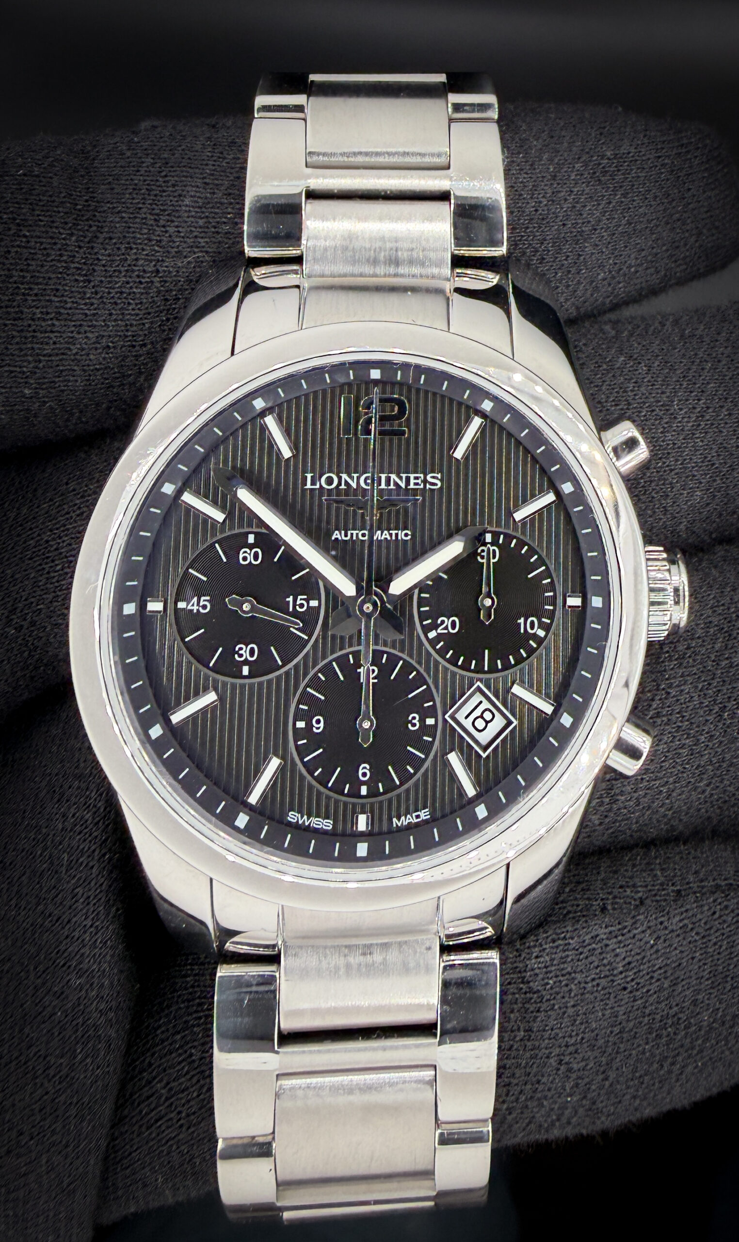 Offered here is the Longines Conquest Classic Cronograph L2.786.4 in its striking black dial configuration, featuring polished silver hands and applied Arabic numerals for sharp contrast and excellent legibility. The polished stainless steel case measures approximately 41mm and presents with the timeless proportions that define the Master Collection line. This Longines includes a new Wrist Wraith travel case; original warranty card; instruction book; and original purchase receipt. Accuracy Testing: +5 Spd / 293 amplitude / .3ms beat error