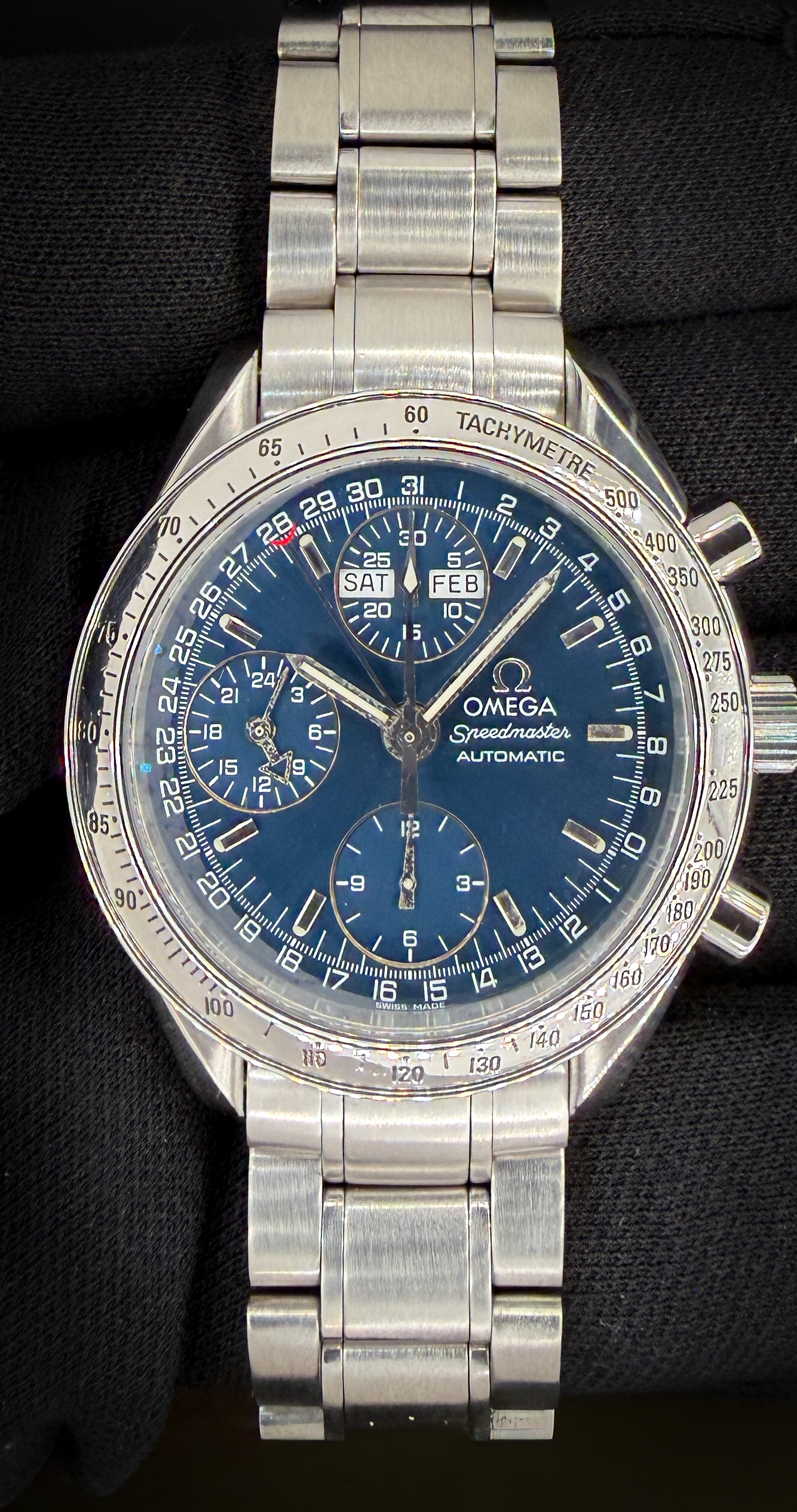 Offered here is the vintage Omega Speedmaster Day-Date Triple Calendar 3523.80.00 in a 39mm stainless steel case, featuring the Omega caliber 1151 automatic movement. Includes the Omega white cardboard box; Wood Case; Omega Travel Box; and TLC Warranty/Authentication card. Caseback Serial Number: 57306XXX