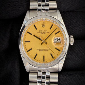 Vintage 1970 Rolex Oyster Perpetual Date, powered by the Rolex caliber 1570 automatic movement and featuring a rare matte gold dial. The dial presents with applied baton hour markers, matching gold hands, “T Swiss T” tritium designation, and classic acrylic crystal with Cyclops date magnification. The stainless steel case measures approximately 34mm, delivering the timeless proportions that define early 1970s Date references. The warm matte gold dial paired with the steel case gives this piece a distinctive and uncommon look within the reference. Case Serial Number: 2514XXX This example was serviced in February 2026 and is running well. Accuracy Testing: +/-5 seconds per day / 274 amplitude / 0.1ms beat error