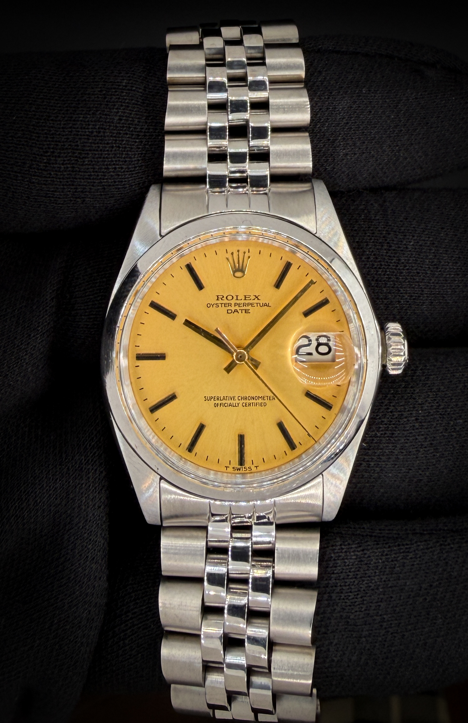 Vintage 1970 Rolex Oyster Perpetual Date, powered by the Rolex caliber 1570 automatic movement and featuring a rare matte gold dial. The dial presents with applied baton hour markers, matching gold hands, “T Swiss T” tritium designation, and classic acrylic crystal with Cyclops date magnification. The stainless steel case measures approximately 34mm, delivering the timeless proportions that define early 1970s Date references. The warm matte gold dial paired with the steel case gives this piece a distinctive and uncommon look within the reference. Case Serial Number: 2514XXX This example was serviced in February 2026 and is running well. Accuracy Testing: +/-5 seconds per day / 274 amplitude / 0.1ms beat error