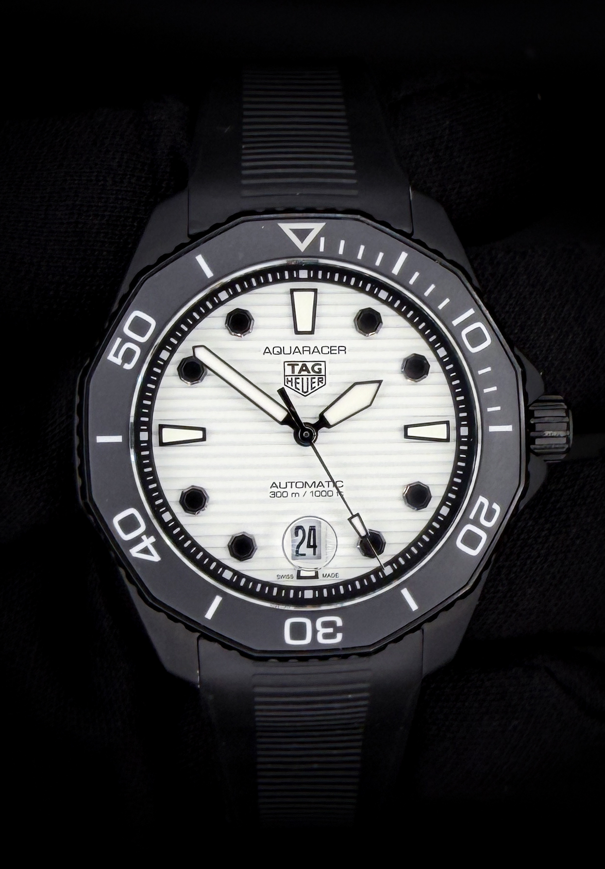 Offered here is the Tag Heuer Aquaracer Professional 300 reference WBP201D, featuring the highly desirable “Full Lume Dial” configuration. The fully luminescent dial delivers exceptional low-light visibility, paired with bold applied markers, a clean date aperture at 6 o’clock, and the signature unidirectional rotating bezel. The stainless steel case measures approximately 43mm, offering a modern and substantial wrist presence while maintaining the rugged, purpose-built design the Aquaracer line is known for. Accuracy Testing: +/- 0 SPD / 313 Amplitude / .1ms Beat Error This example includes the full set: original outer box, inner box, instruction booklet, and warranty card dated September 28th, 2023. The watch is currently fitted to the original black rubber strap, sized to fit approximately a 7.75-inch wrist.
