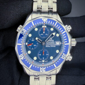 Offered here is the Omega Seamaster 300 Chronograph reference 2599.80.00, circa 2000, featuring the iconic blue wave dial with luminous sword hands, applied hour markers, and matching blue bezel. The stainless steel case measures approximately 42mm and is powered by the Omega caliber 1164 automatic chronograph movement, delivering reliable performance in a robust, tool-oriented platform. This reference represents a classic era of Seamaster design, blending professional dive watch capability with everyday versatility. Case Serial Number: 60027XXX