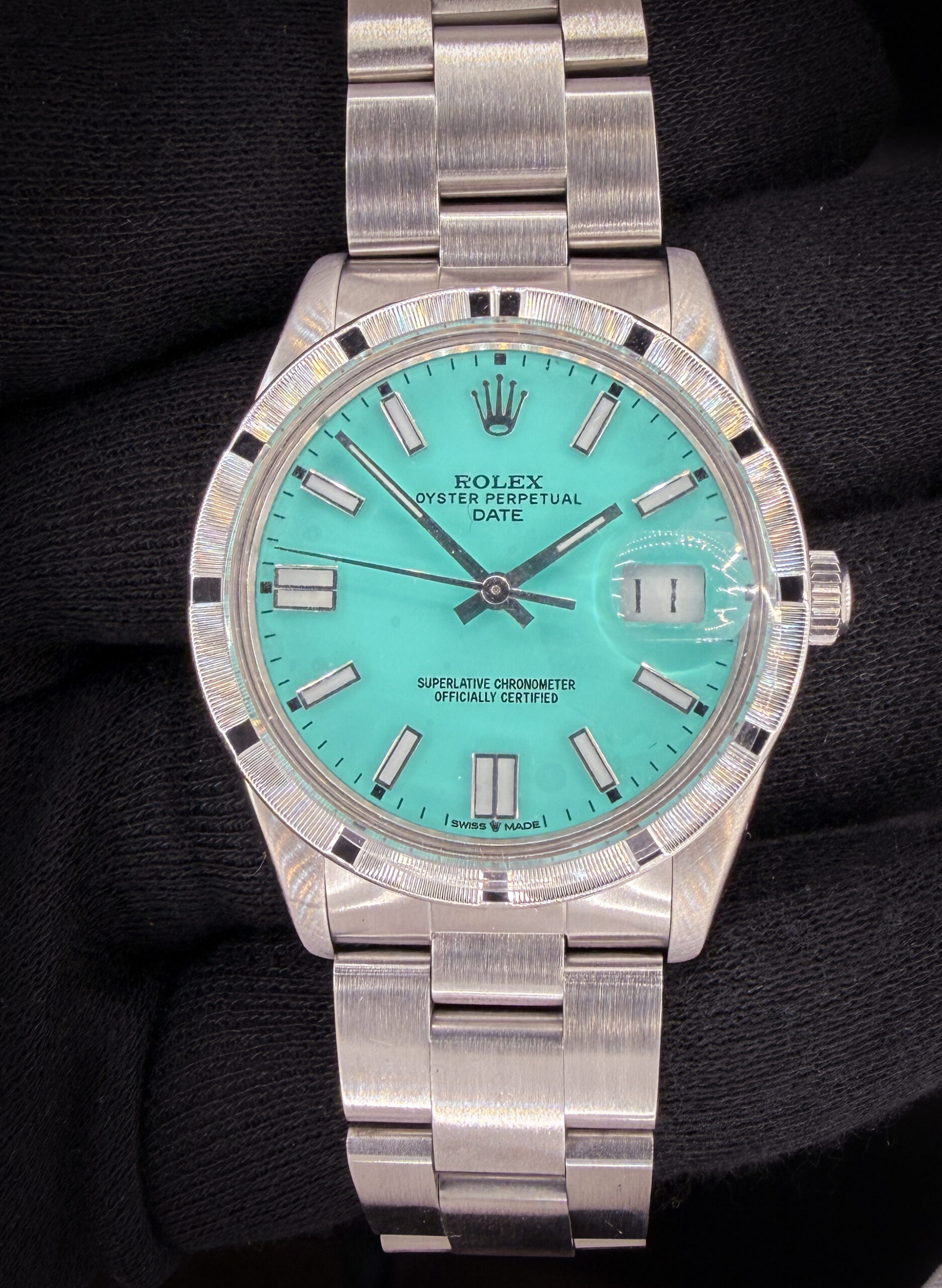 1984 Rolex Oyster Perpetual Date 15010 in a 34mm stainless steel case, powered by the Rolex 3035 automatic movement. This watch is paired with a new customized Tiffany-Blue dial. Includes the original outer box, inner case, Oyster Booklet, Instruction booklet, TLC Warranty/Authentication card, as well as the original Rolex silver stick dial. Case Serial Number: 8180XXX