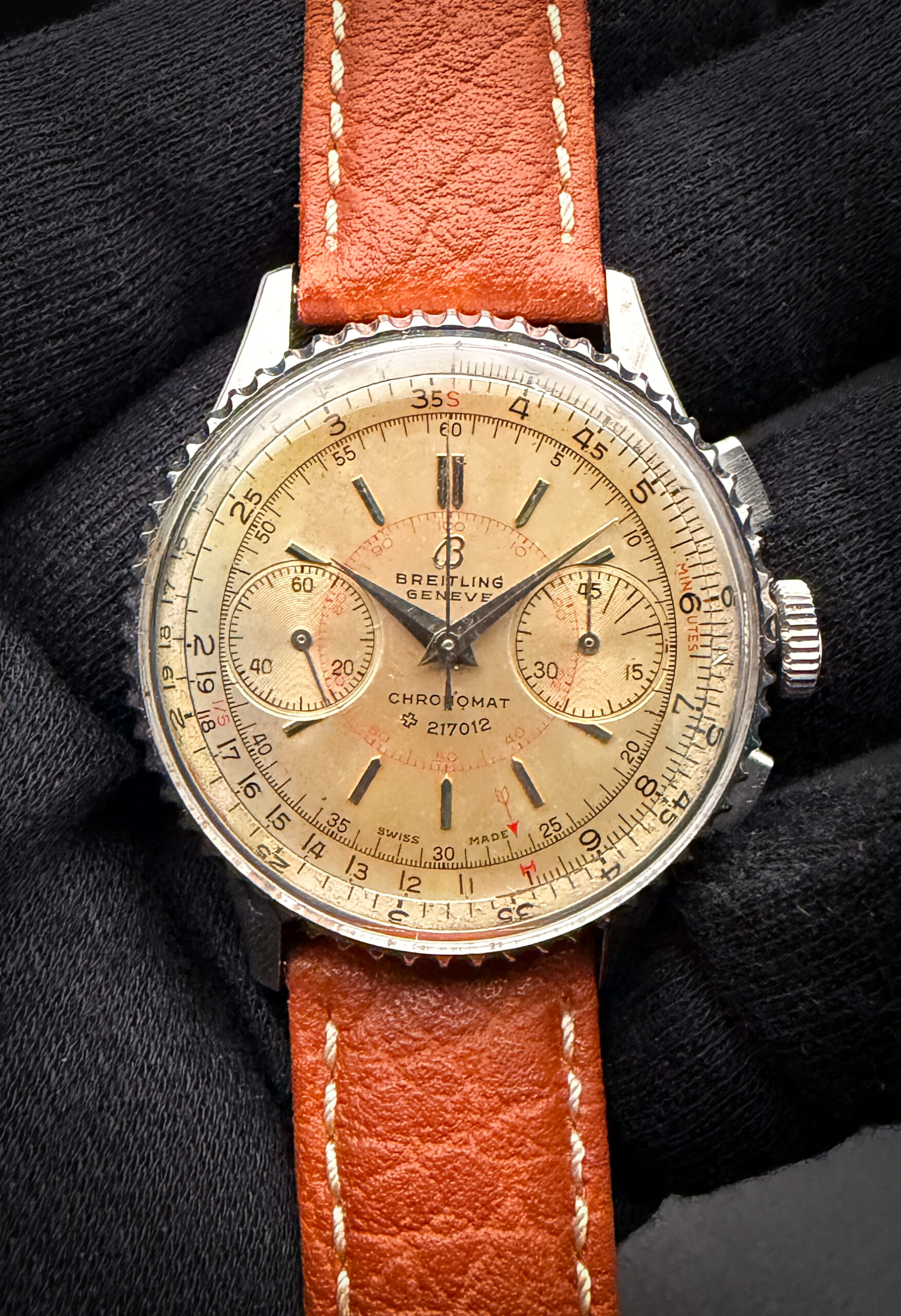 Vintage Breitling Chronomat “217012,” reference 769, featuring the iconic patent slide-rule bezel marked, housed in a 36mm stainless steel case and powered by the legendary manual-wind Venus 175 chronograph movement. Produced circa 1947, this early Chronomat represents one of the most historically important references in Breitling’s catalog, serving as the direct predecessor to the Navitimer and introducing the circular slide-rule concept that would define the brand for decades to come. The warm silver dial has developed a rich and even vintage patina, complemented by applied hour markers, silver hands, twin recessed sub-registers, and striking red calculation scales that give the watch exceptional depth and character. Serial Number: 704283