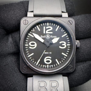Bell and Ross BR01-92-S Diver in a 46mm square case, featuring the ETA 2892 automatic movement. This BR has been tested in excellent working order and is ready for wear. Includes a New Wrist Wraith watch roll, and a TLC Warranty/Authentication Card. The crystal is clear and free of scratches or mars. The original dial and hands are pristine with no stains or discoloration. Overall the case is in good condition, with no significant scratches or dents. The black PVD coating has light wear along the case and bezel edges, giving this watch an excellent military appearance. This BR is paired with the original black rubber strap with black buckle.