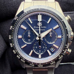 Grand Seiko Tentagraph SLGC001 in a high-intensity titanium case measuring approximately 43.2mm in diameter, representing Grand Seiko’s first fully mechanical chronograph and one of the brand’s most technically advanced sport watches to date. The Tentagraph draws clear inspiration from the legendary design language established by the Grand Seiko Evolution 9 Collection, combining razor-sharp Zaratsu polishing, deeply textured dial work inspired by Mount Iwate, and an aggressively faceted case architecture that reflects both Japanese industrial precision and modern luxury sports chronograph design. While unmistakably Grand Seiko in execution, collectors often note parallels to elite integrated luxury chronographs from brands such as Audemars Piguet and Zenith through its combination of titanium construction, high-beat movement technology, and technical finishing.