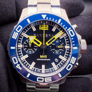 Panzera Mecha Chronograph M45C-01 featuring a striking blue dial with matching blue ceramic tachymeter bezel, housed in a bold stainless steel case and paired with the original stainless steel bracelet for a modern luxury sport-chronograph presence. The design draws inspiration from iconic racing chronographs such as the Rolex Daytona and TAG Heuer Carrera, blending aggressive sport styling with contemporary Australian design language.