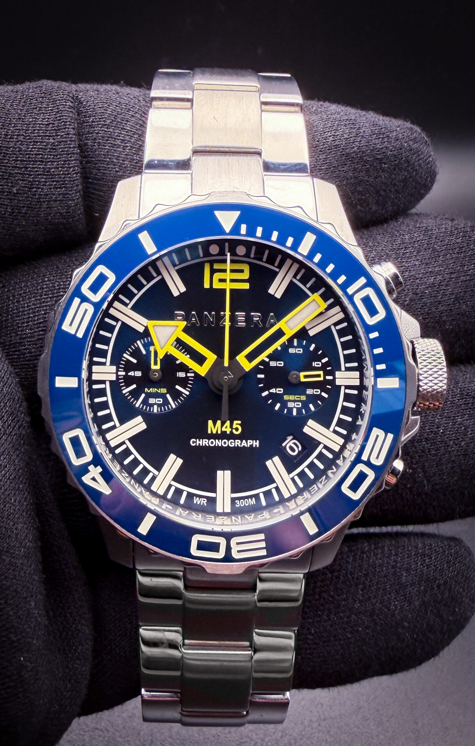 Panzera Mecha Chronograph M45C-01 featuring a striking blue dial with matching blue ceramic tachymeter bezel, housed in a bold stainless steel case and paired with the original stainless steel bracelet for a modern luxury sport-chronograph presence. The design draws inspiration from iconic racing chronographs such as the Rolex Daytona and TAG Heuer Carrera, blending aggressive sport styling with contemporary Australian design language.