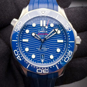 The Omega Seamaster Diver 300M Ref. 210.30.42.20.03.001 is a modern luxury dive watch housed in a 42mm stainless steel case and powered by Omega's Master Chronometer Caliber 8800 automatic movement. Featuring a striking blue ceramic wave-pattern dial, matching ceramic bezel, 300-meter water resistance, and the iconic helium escape valve, this Seamaster blends professional-grade performance with the refined styling that has made the model a favorite of collectors and James Bond enthusiasts alike. This Omega includes both the Blue rubber strap with double fold buckle; and the Omega stainless steel bracelet with micro-adjustment buckle. The bracelet is fully linked. Serial Number: 84275XXX This Seamaster includes the full kit: Outer Box, Inner wooden case; instruction book; leatherette wallet, hang-tag, chronometer card; pictogram card; and warranty card (7-10-24); as well as the original sales receipt