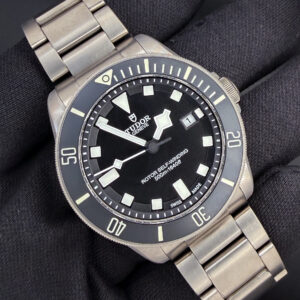 Tudor Pelagos Titanium 25500TN "Two-Liner" in a 42mm titanium case. This Tudor includes: Outer Sleeve; Inner Box; Case; Instruction Book; Decal; Booklet Sleeve; Rubber Strap; Rubber Strap Extension; Service Pouch; Service Card; and Original Warranty Card. Serial Number: J883XXX