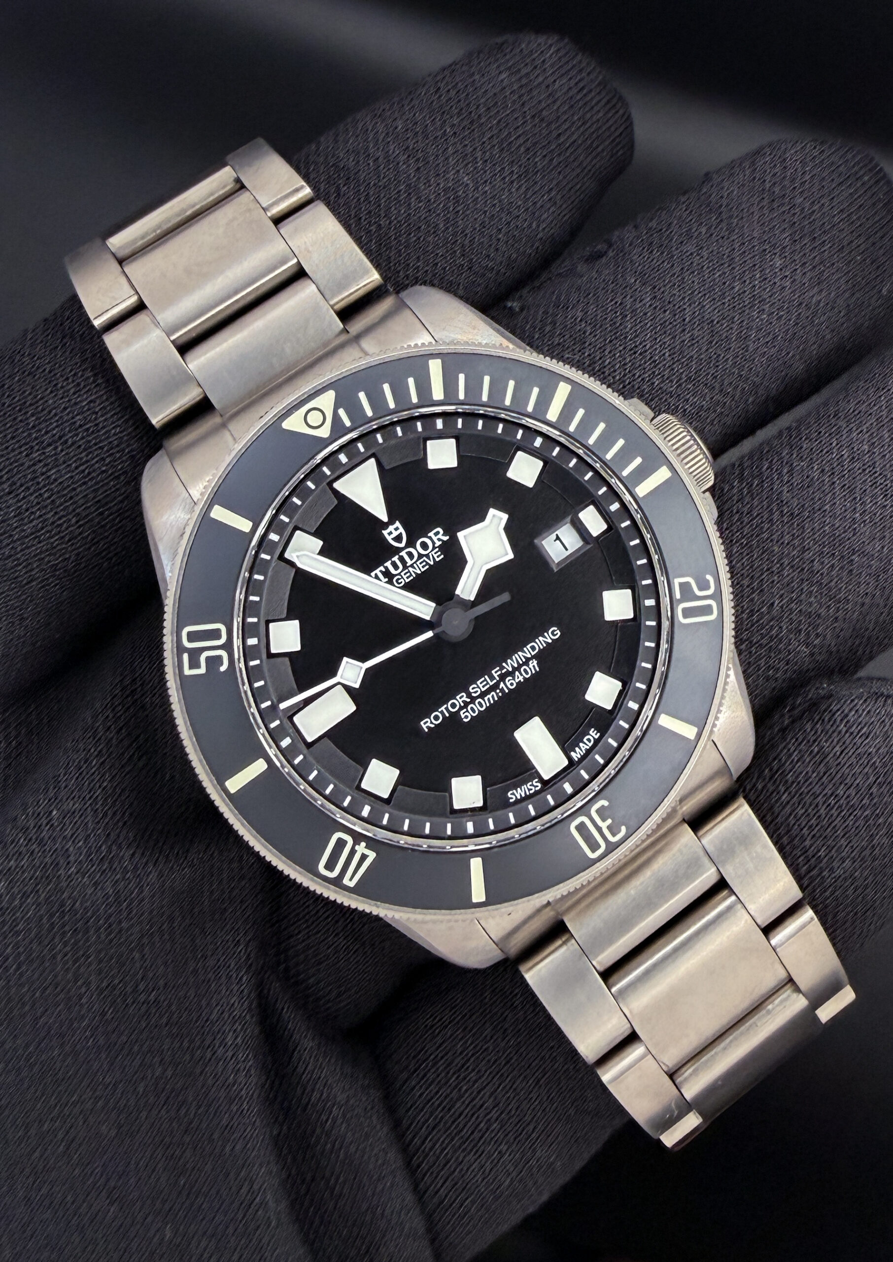 Tudor Pelagos Titanium 25500TN "Two-Liner" in a 42mm titanium case. This Tudor includes: Outer Sleeve; Inner Box; Case; Instruction Book; Decal; Booklet Sleeve; Rubber Strap; Rubber Strap Extension; Service Pouch; Service Card; and Original Warranty Card. Serial Number: J883XXX