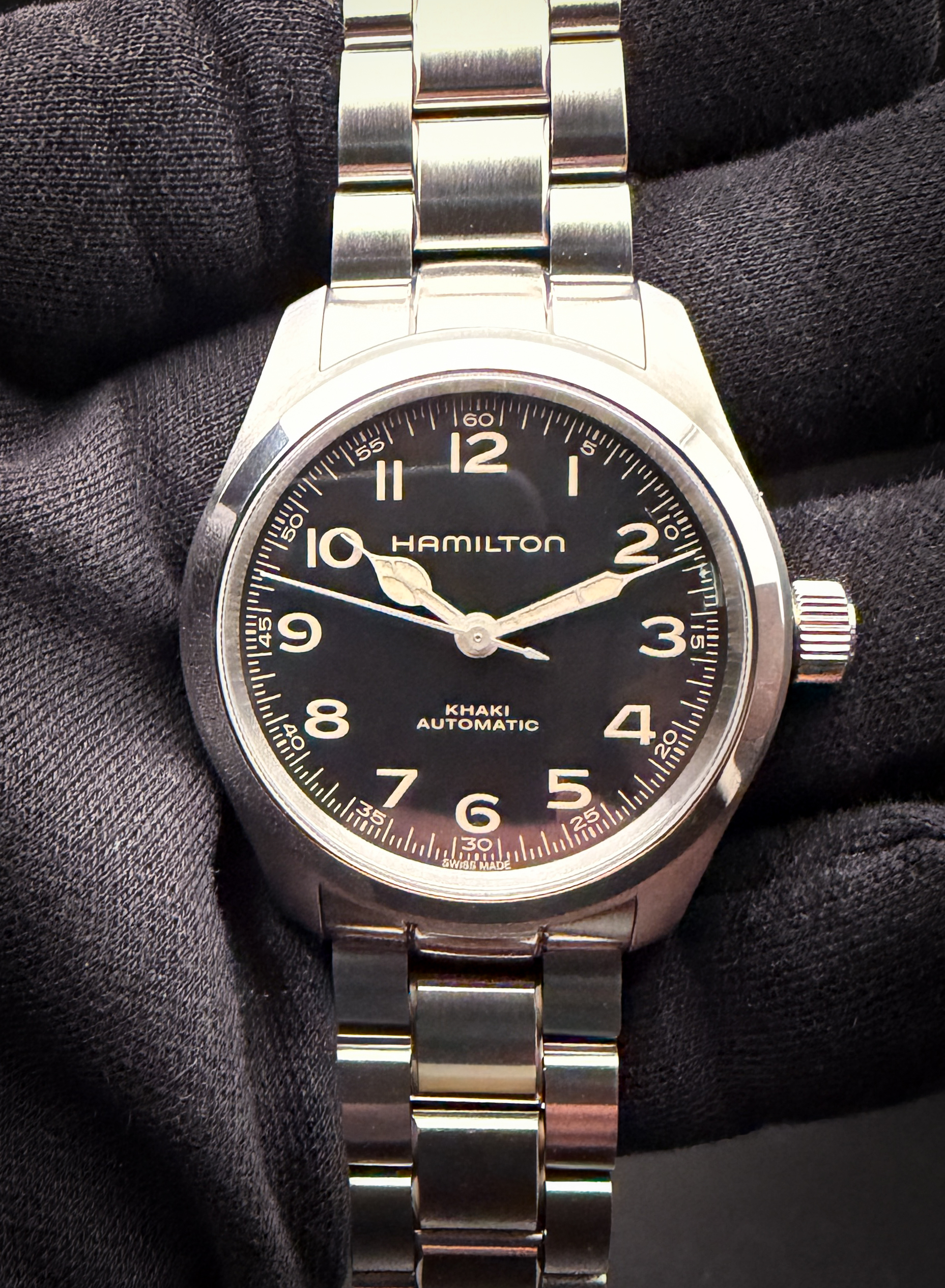 Hamilton Khaki Field "Murph" 38mm H704050 in a 38mm stainless steel case, powered by the ETA CO7611+ automatic movement. This Hamilton is in excellent condition and ready to wear. Includes: Outer Box; Inner Case; Instruction Book; Tan Nylon two-piece strap; and Open Warranty Card.