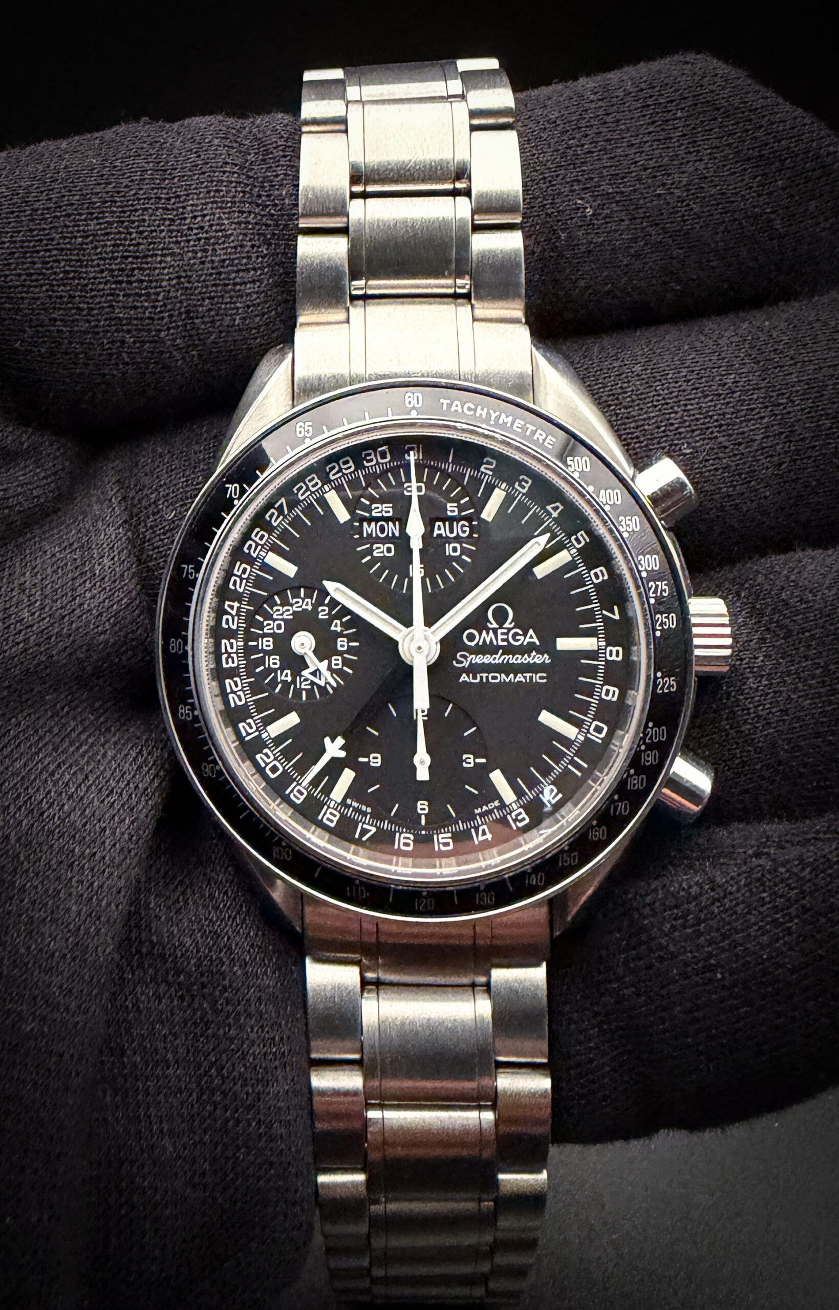 Vintage Omega Speedmaster Day-Date 3520.50.00 in a 39mm stainless steel case, featuring the Omega calibre 1151 automatic movement. This Speedmaster has been tested in excellent working order and is ready for wear. Includes: Omega outer box; inner leatherette case; wallet; instruction book; hang tag (matching serial); and warranty card.  Accuracy Testing: +/-3 SPD / 294 Amplitude / .1ms Beat Error Case Serial number: 57308XXX