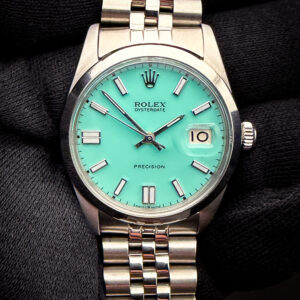 Vintage 1967 Rolex Oyster Date Precision 6694, in a 34mm stainless steel case, featuring a custom teal-blue dial, powered by the Rolex hand-wound 1225 movement. This Rolex has been tested in excellent working order and is ready for daily wear. Accuracy Testing: +6 SPD / 262 Amplitude / .1ms Beat Error Case Serial Number: 1530XXX