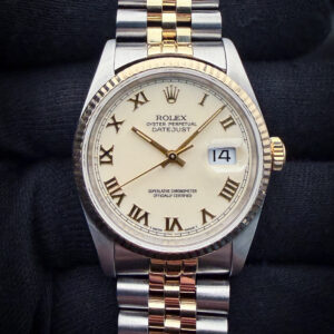 1991 (X-Serial) Rolex 16220 in a 36mm stainless steel and yellow gold case, featuring the rare cream roman numeral dial, and powered by the Rolex 3135 automatic movement. This Rolex was serviced in September 2026 and is ready for wear or to be added to a collection. Accuracy Testing: +/-5 SPD / 285 Amplitude / .2ms Beat Error Case Serial Number: X209XXX