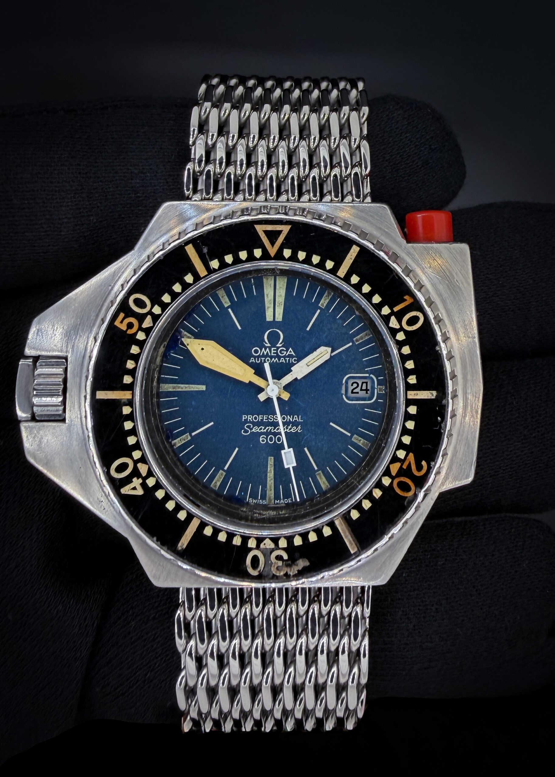 The original Omega Seamaster PloProf 166.077. This PloProf was fully serviced by Omega-Authorized TM Watch Company in September 2026 and is ready for daily wear or to be added to a collection: Includes full service documentation; travel case; and our TLC Warrant & Authentication Card. This watch is stunning in every way. The crystal is clean with no scratches or mars. The original dial is beautiful with a light patina and fading. The original hands show a matching patina and fading with the dial. The original bakelite bezel is gorgeous with light marks consistent with 50 years of age. The case is in wonderful vintage condition with light marks consistent with age, but no significant scratches or dents.
