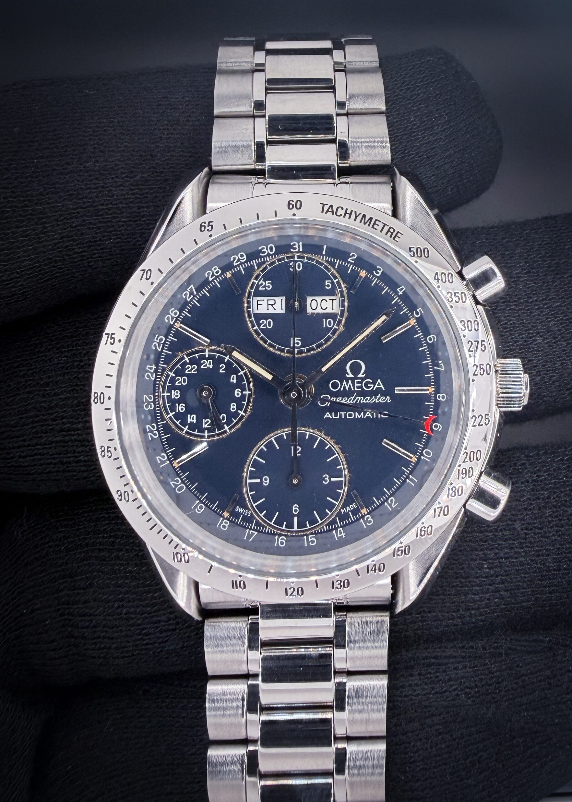 1995 Omega Speedmaster Triple Calendar Day-Date 3521.80.00, in a 39mm stainless steel case, powered by the Omega 1150 automatic movement. Includes: white Omega outer box; inner case; and Warranty Card (dated '95.3.27) Accuracy Testing: +1 SPD / 271 Amplitude / .0ms Beat Error Case Serial Number: 54758XXX