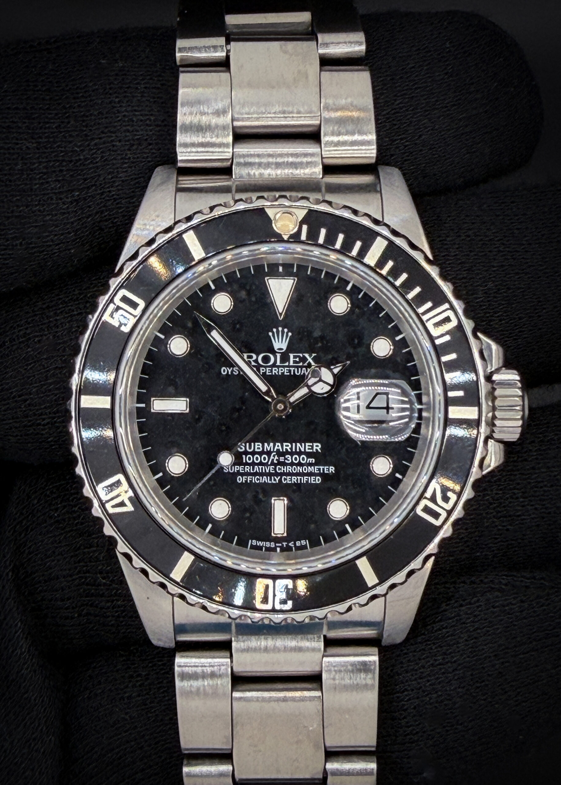 1988 Rolex Submariner Date 168000 "Triple-Zero" "Ghost Reference"  in a 40mm stainless steel case, featuring the Rolex calibre 3035 automatic movement. This Rolex has been tested in excellent working order and is ready for wear or to be added to a collection. Includes a new Wrist Wraith watch roll and the TLC Authentication and Warranty Card.  Case Serial Number: R594XXX