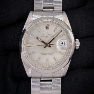 Vintage 1966 Rolex Oyster Perpetual Date reference 1500, featuring the original silver sunburst dial, classic acrylic crystal with Cyclops date magnification. The stainless steel case measures approximately 34mm, delivering the timeless proportions that define vintage Date references. This Rolex was serviced in October 2026, and the caseback features three distinct service marks. Case Serial Number: 1447XXX