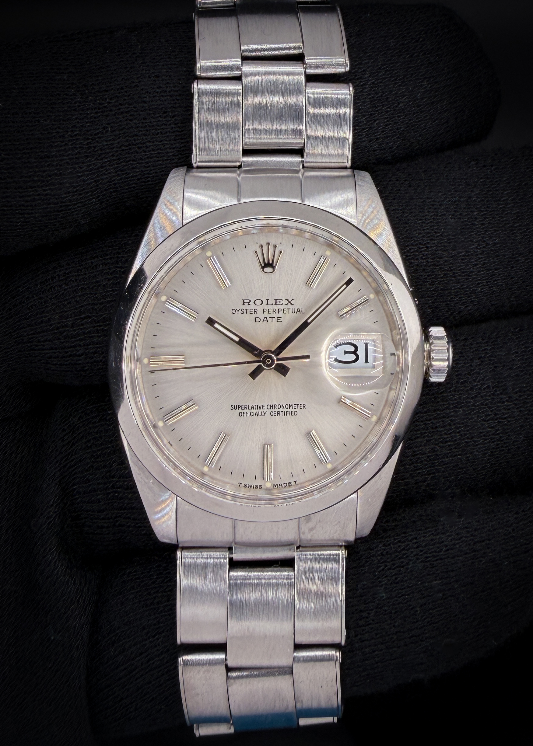 Vintage 1966 Rolex Oyster Perpetual Date reference 1500, featuring the original silver sunburst dial, classic acrylic crystal with Cyclops date magnification. The stainless steel case measures approximately 34mm, delivering the timeless proportions that define vintage Date references.  This Rolex was serviced in October 2026, and the caseback features three distinct service marks.  Case Serial Number: 1447XXX