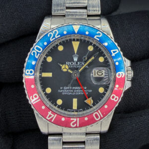 Offered is a highly desirable, early-production Rolex GMT-Master Ref. 16750 "Pepsi," dating to circa 1980, serial number 6,303,XXX. This collectible transitional GMT-Master features a genuine Rolex matte black tritium dial with beautifully preserved yellow-cream hour markers, aged tritium hands, and a striking faded blue-and-red aluminum bezel insert. The dial retains its vintage matte finish, and its manufacturer's markings were inspected during the recent professional movement service. The stainless steel 40mm Oyster case is accompanied by a genuine Rolex Oyster bracelet, reference 78360, fitted with the correct 580 end links. Powered by the reliable Rolex caliber 3075 automatic movement, featuring a quickset date and 28,800 bph frequency, the watch has recently been professionally serviced, including installation of a new mainspring and acrylic crystal. The dial, hands, bezel, and other vintage cosmetic components have been preserved, maintaining the watch's authentic period appearance. The case and bracelet exhibit age-appropriate wear. With its early 6.3-million serial number, desirable matte tritium dial, beautifully developed patina, and period-correct Rolex Oyster bracelet, this GMT-Master offers an outstanding combination of vintage Rolex collectibility and everyday functionality. Accuracy Testing: +5 SPD / 258 Amplitude / .4ms Beat Error Case Serial Number: 6303XXX This Rolex is paired with the Rolex Oyster 78360 Stainless steel bracelet with 580 end-links. The bracelet has two (2) removable links currently installed and will fit up to a 7.5 inch wrist. 