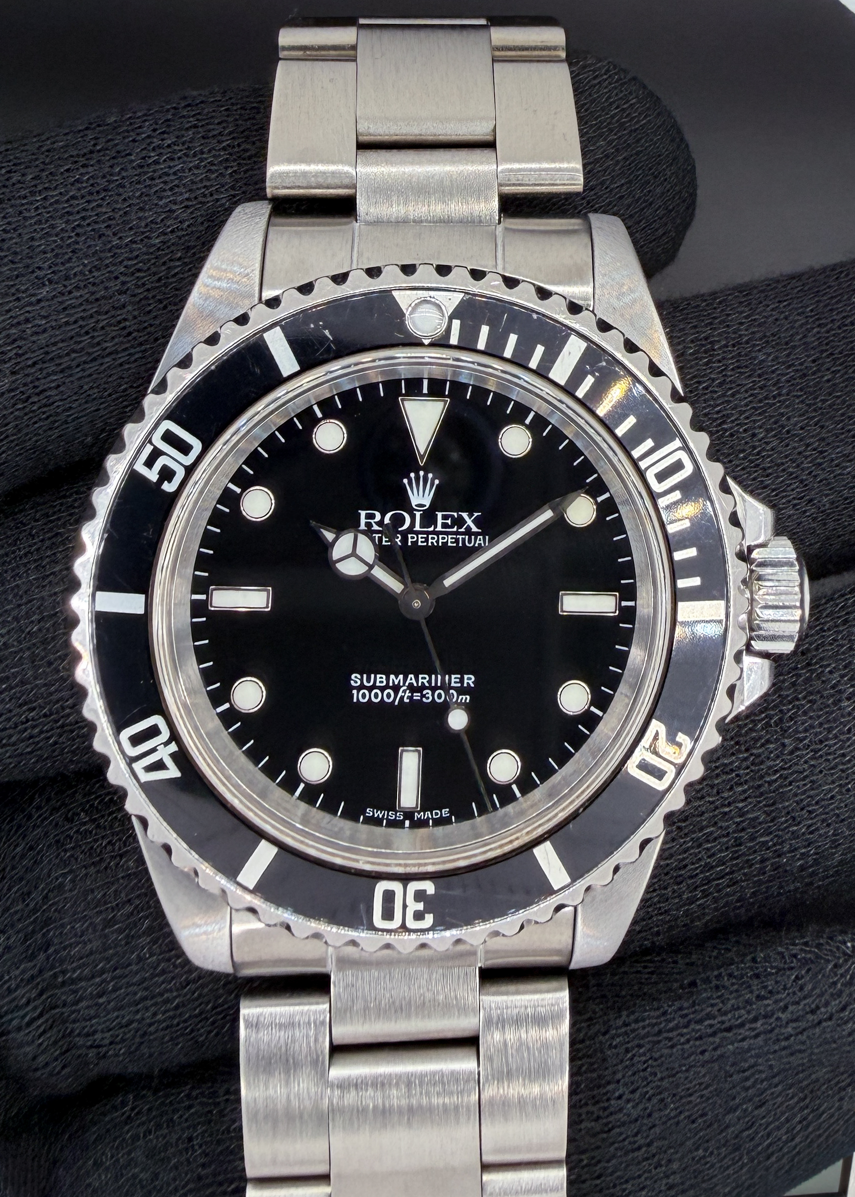 1999 (A-Serial) Rolex 14060 Submariner "No-Date" in a 40mm stainless steel case, powered by the Rolex caliber 3000 automatic movement. This Submariner has been tested in good working order and is ready for wear or to be added to a collection. Includes a new Wrist Wraith Travel Roll and the TLC Warranty & Authentication Card.  Case Serial Number: A728XXX Accuracy Testing: -7 SPD / 280 Amplitude / .2ms Beat Error